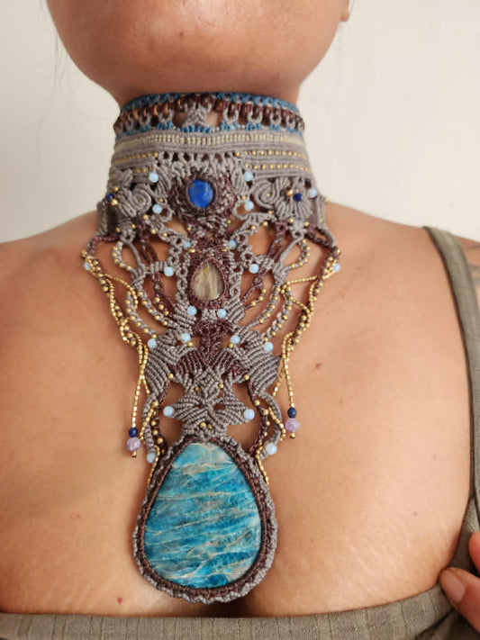Apatite Pendant showcasing a large natural stone with blue and white coloration on a micromacramé choker.
