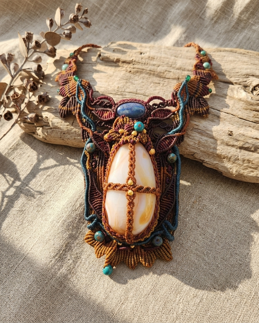 Carnelian Pendant showcasing a large carnelian agate stone in a handmade micromacramé design with lapis lazuli accents.