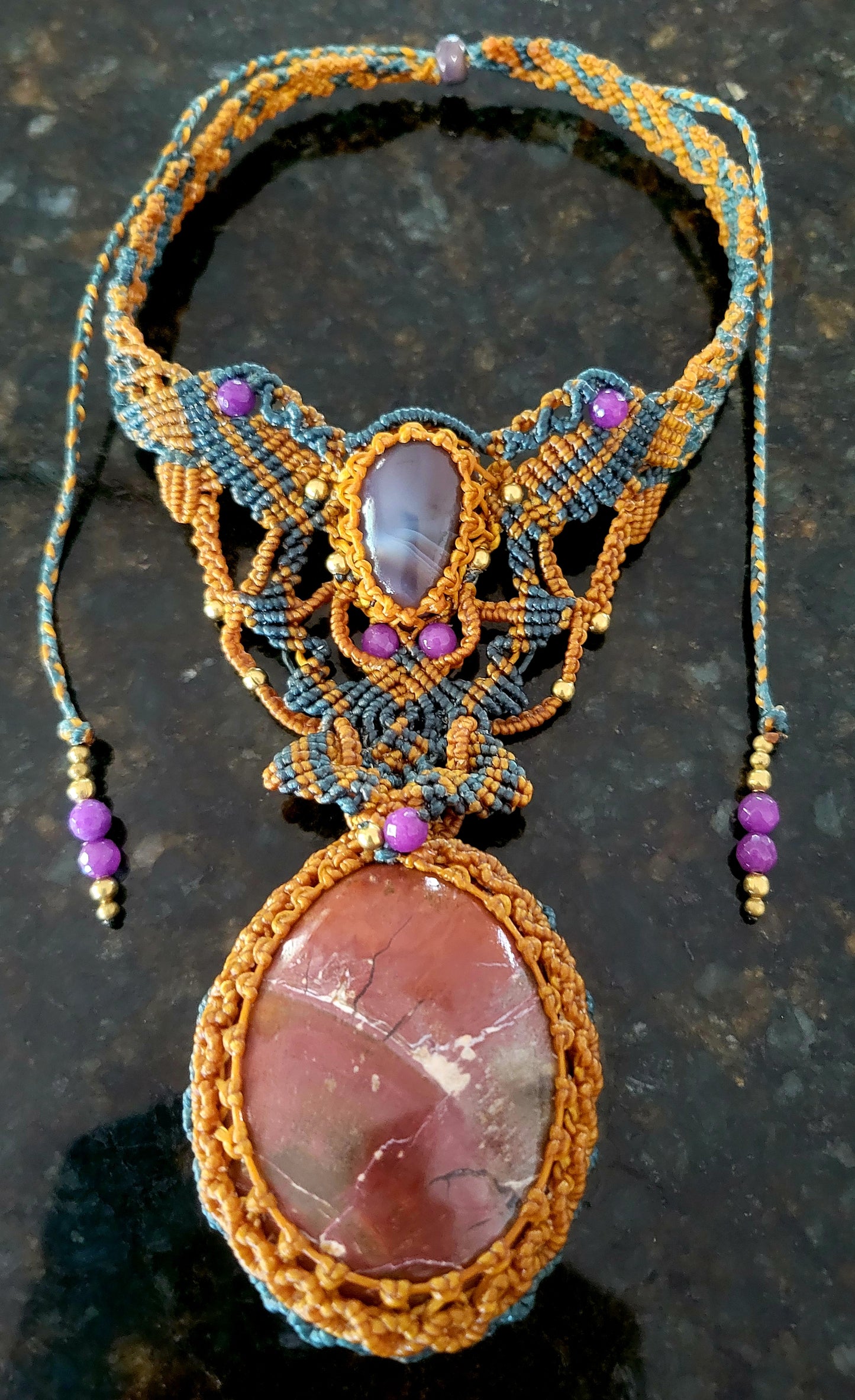 Noreena Jasper Pendant featuring a large rust-red Noreena Jasper stone with Botswana Agate and micromacramé design.
