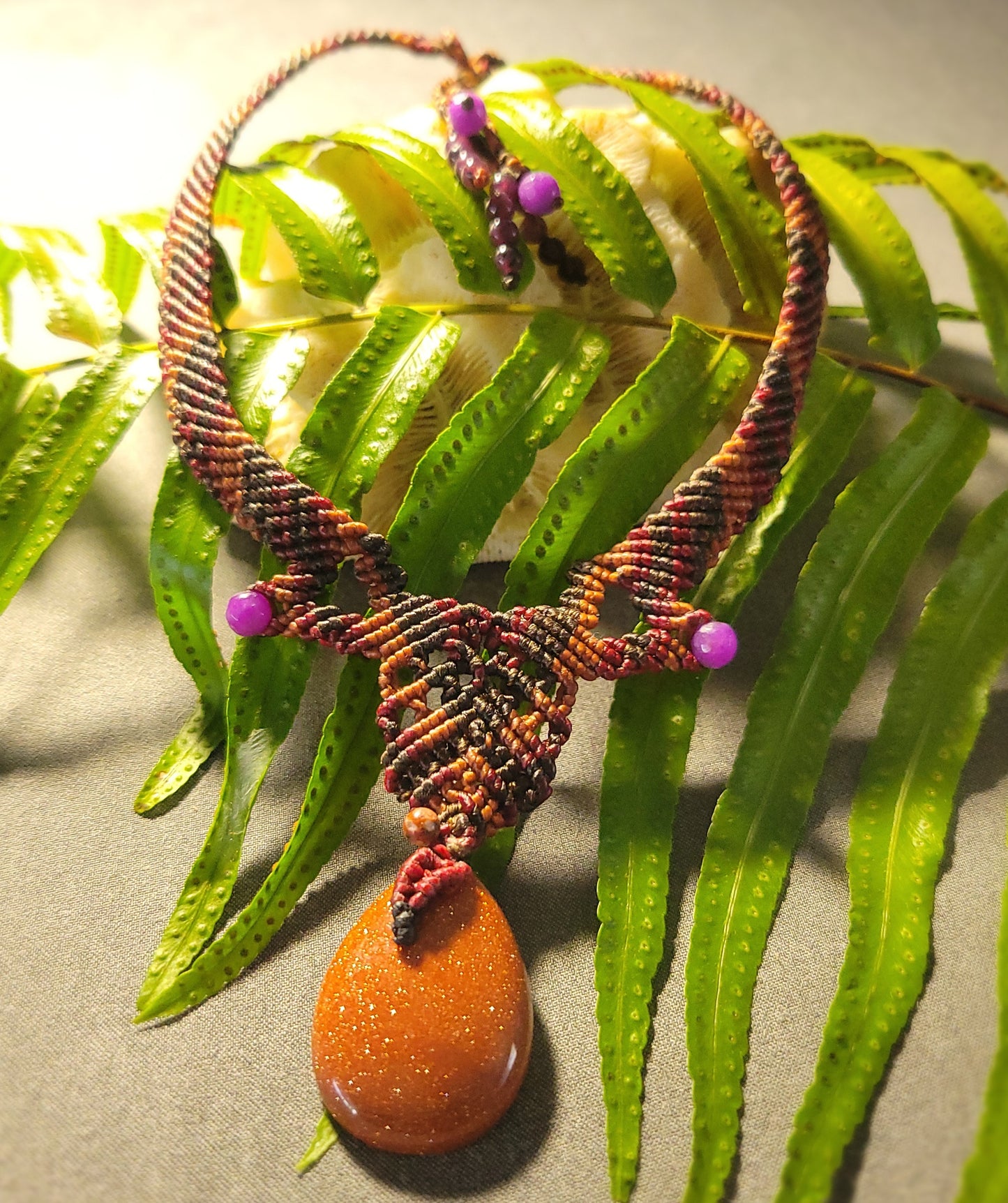 Golden Sand Stone Pendant – Desert Spirit Macramé Necklace featuring shimmering golden sand stone and braided dark brown macramé.