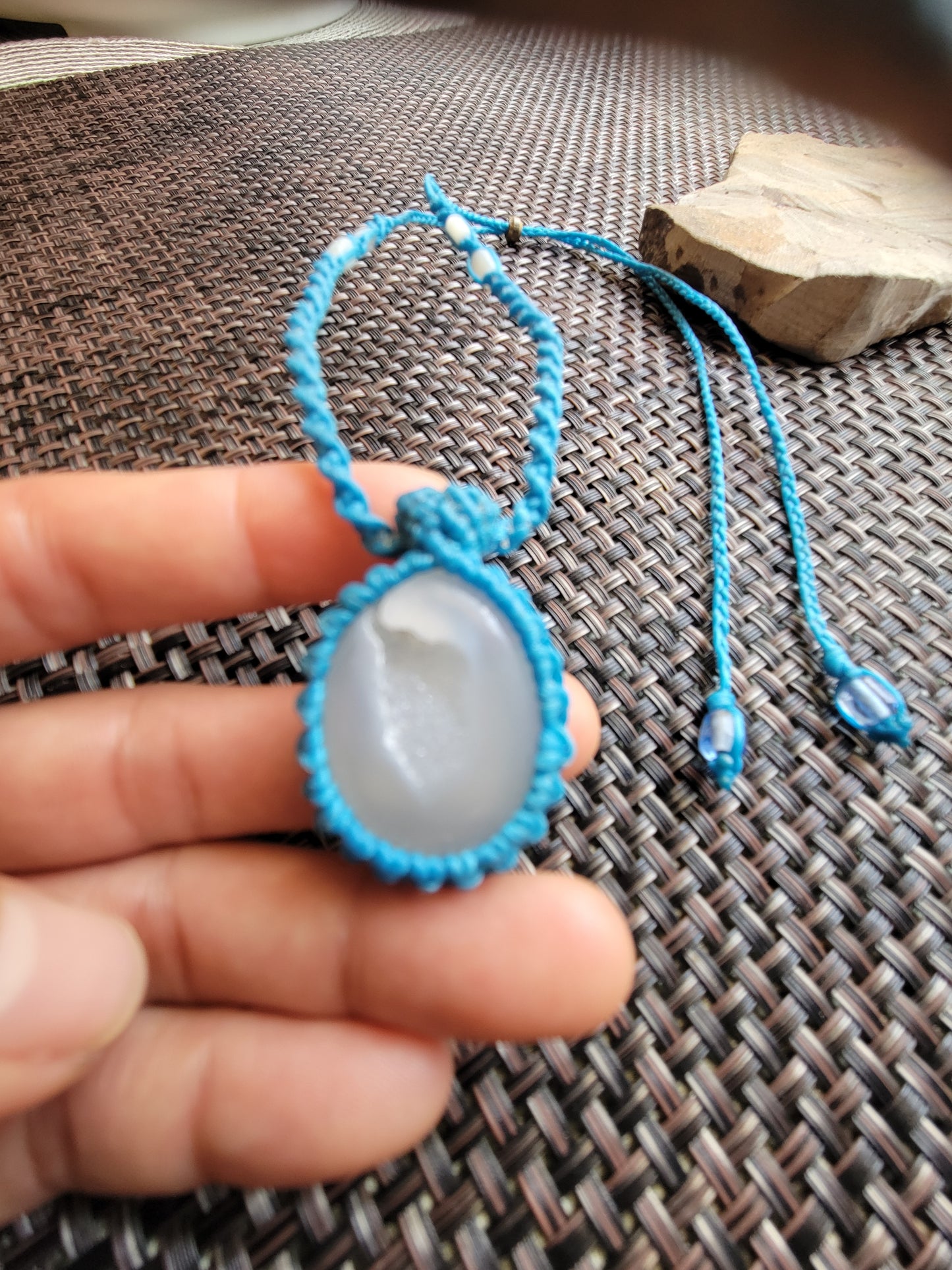 Agate Pendant – White Druzy Minimalist Boho Necklace on a teal adjustable cord held in hand.