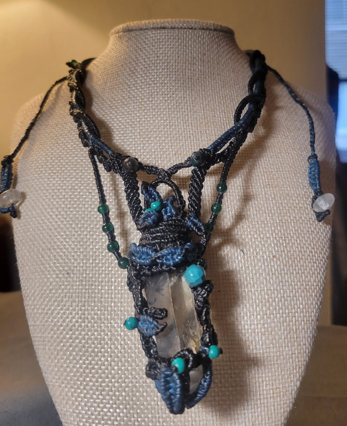 quartz crystal necklace with blue macramé leaves