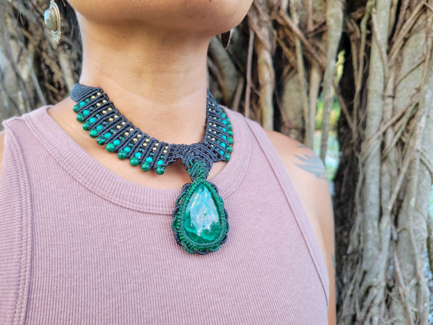 Malachite Pendant Necklace showcasing large natural malachite stone on handmade brown macramé choker with green beads.