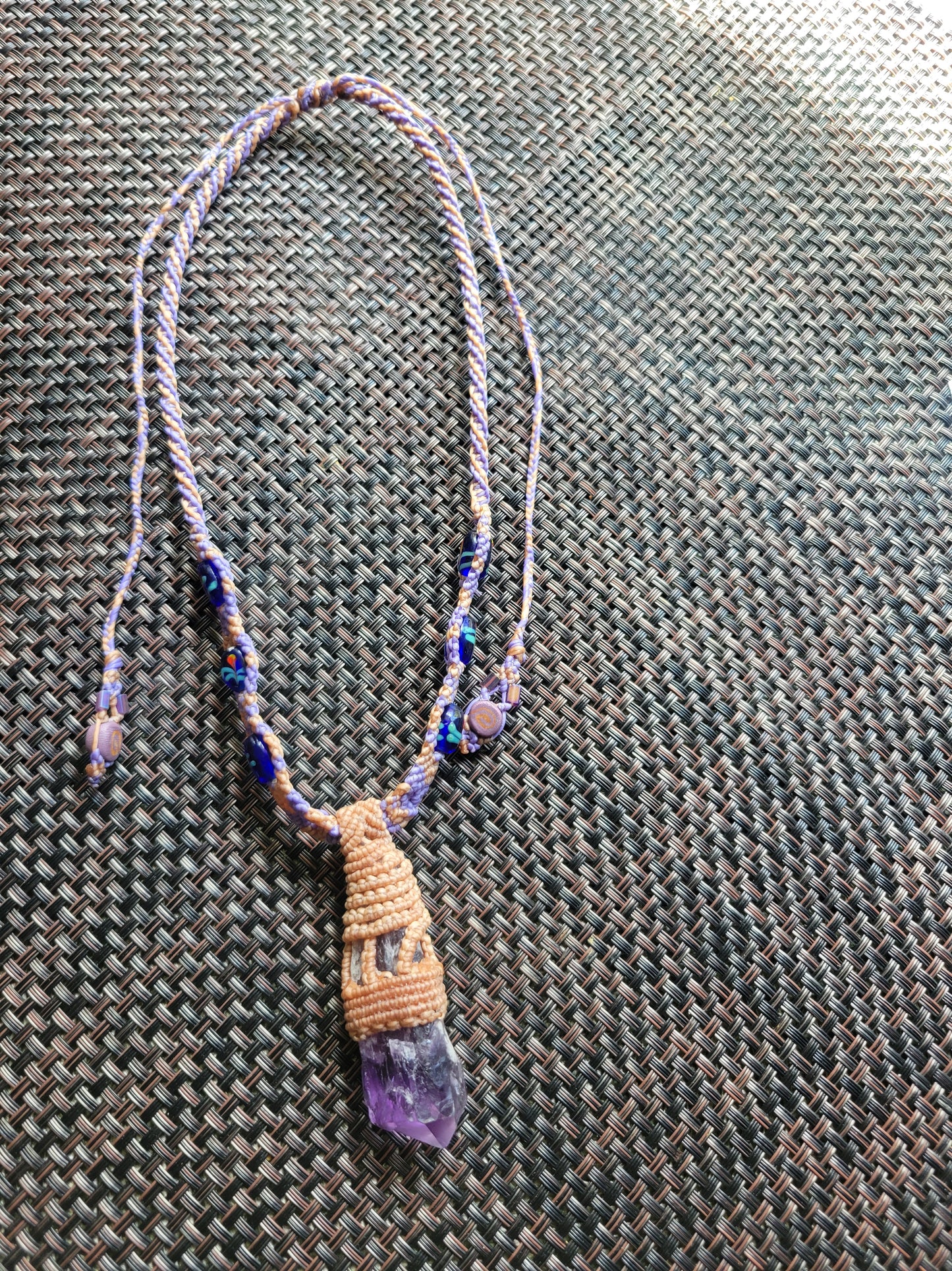 “Sacred Bloom” – Raw Amethyst Crystal Pendant Necklace, Purple & Tan Woven Cord with Blue Beads, Adjustable Feminine Jewelry