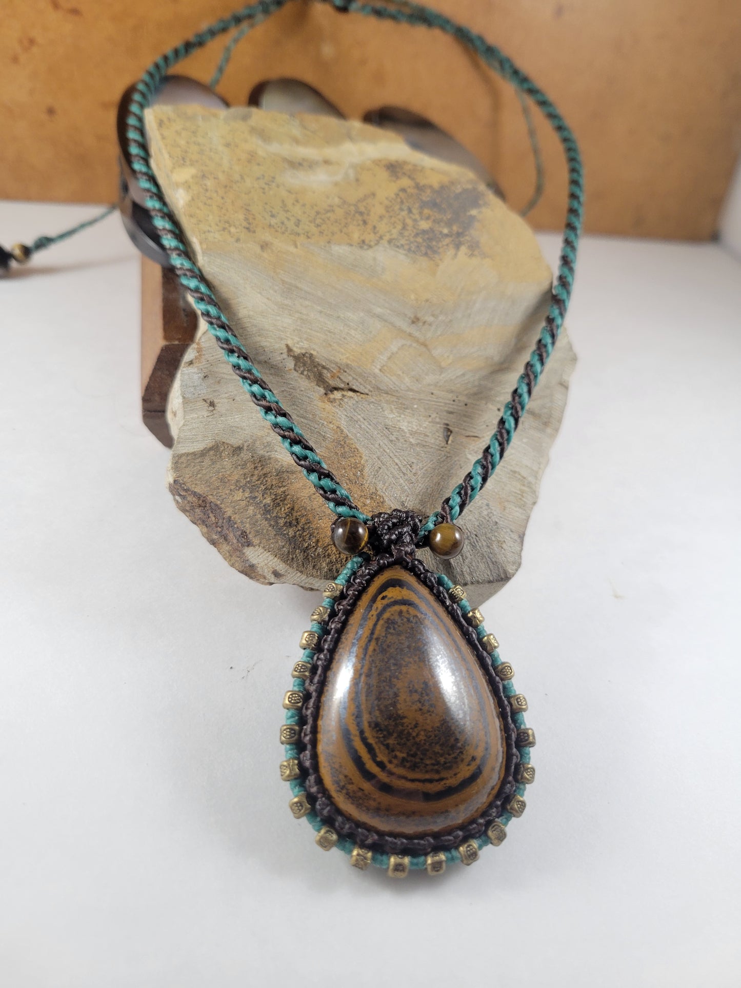 Iron Tiger Eye Pendant Necklace – Black & Blue Macrame with Brass Beads, 16” Bead Closure