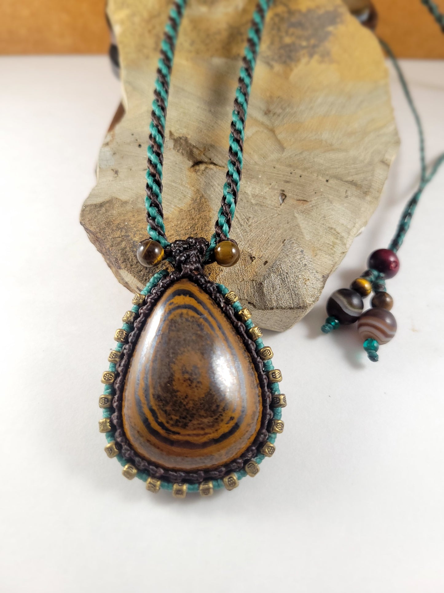 Iron Tiger Eye Pendant Necklace – Black & Blue Macrame with Brass Beads, 16” Bead Closure