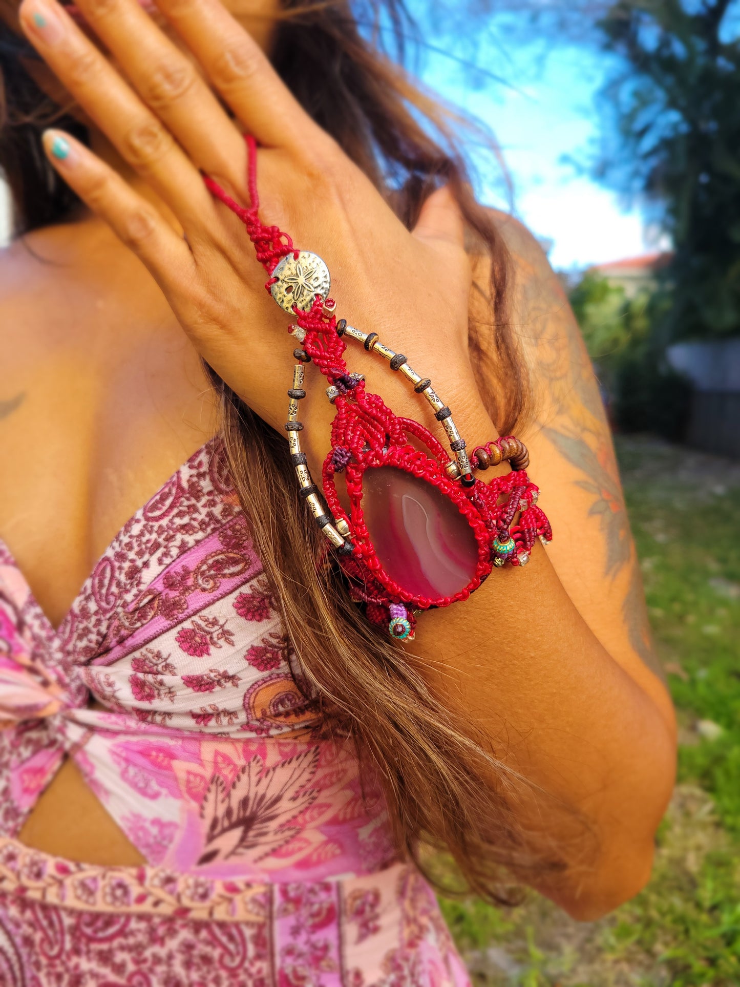 Belly Dancer Bracelet featuring red agate slice, metal charm beads, and handmade boho style for hand or foot wear.
