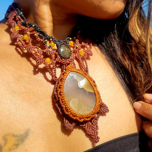 Agate Pendant worn as a necklace, featuring macramé design and natural stones, inspired by sea turtles.