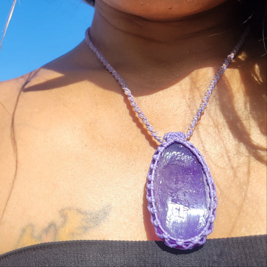 Agate Pendant Necklace featuring a deep purple slice with rope macramé design worn by a model outdoors.