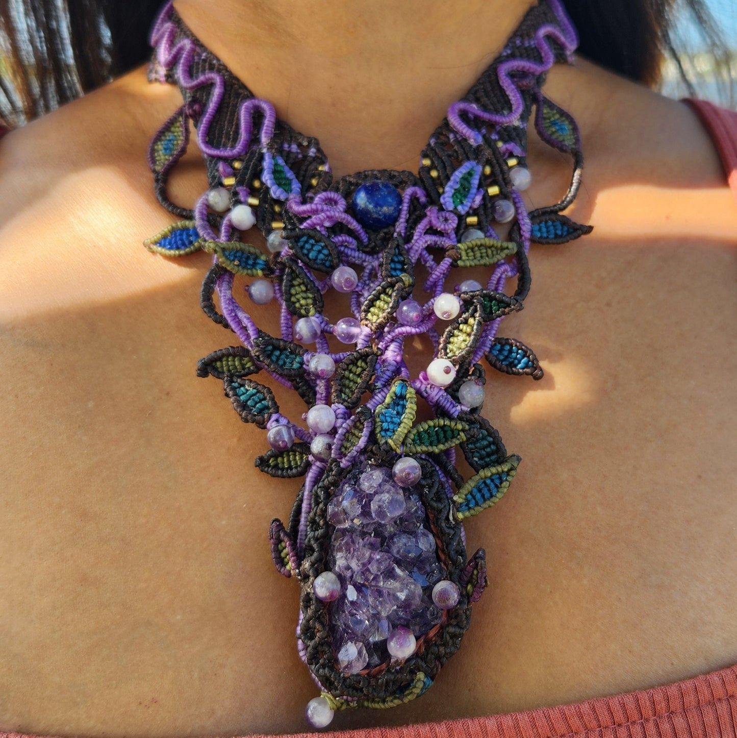 Amethyst Pendant featuring large raw amethyst crystal and intricately designed micromacramé choker with purple accents.