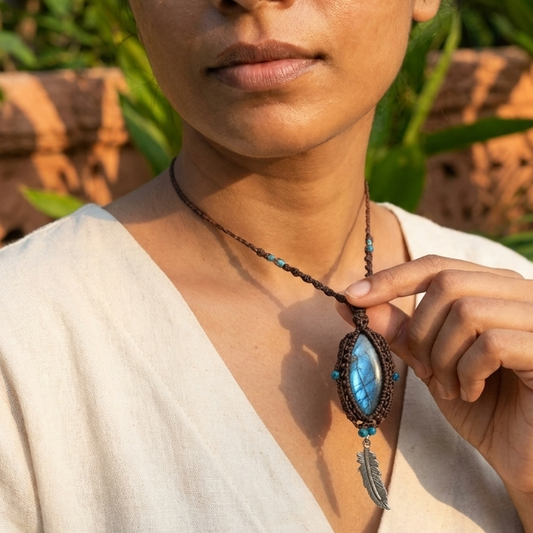 Labradorite Pendant Necklace featuring a natural stone and feather charm, worn in a boho style by a model.