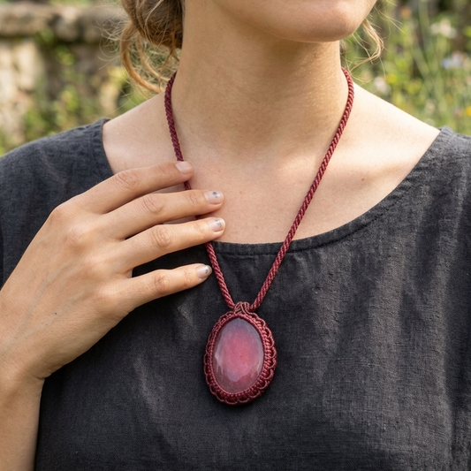 Woman wearing an Agate Pendant Necklace with a red agate slice on a macramé rope, showcasing earthy style.