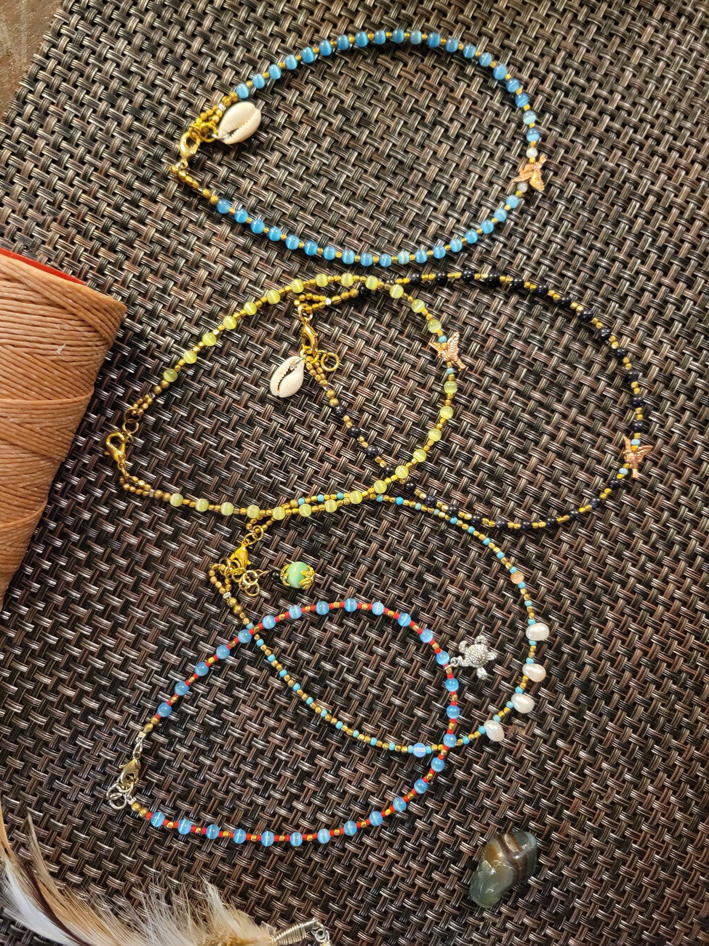 Boho Anklets – Beaded ocean charm anklets featuring assorted colors, shells, and ocean-inspired charms.