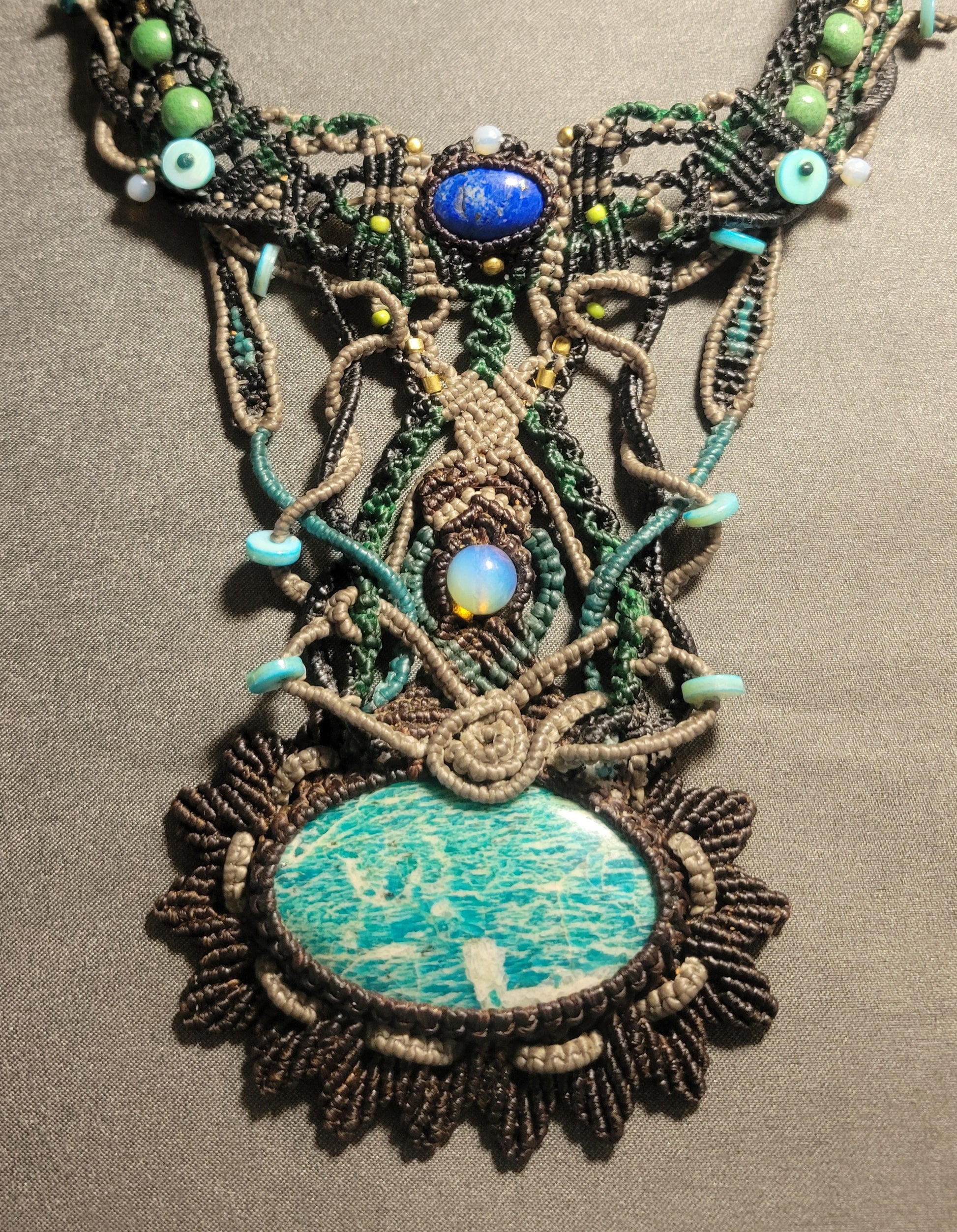 Amazonite Stone Necklace featuring large amazonite pendant and ornate macramé design with assorted beads.