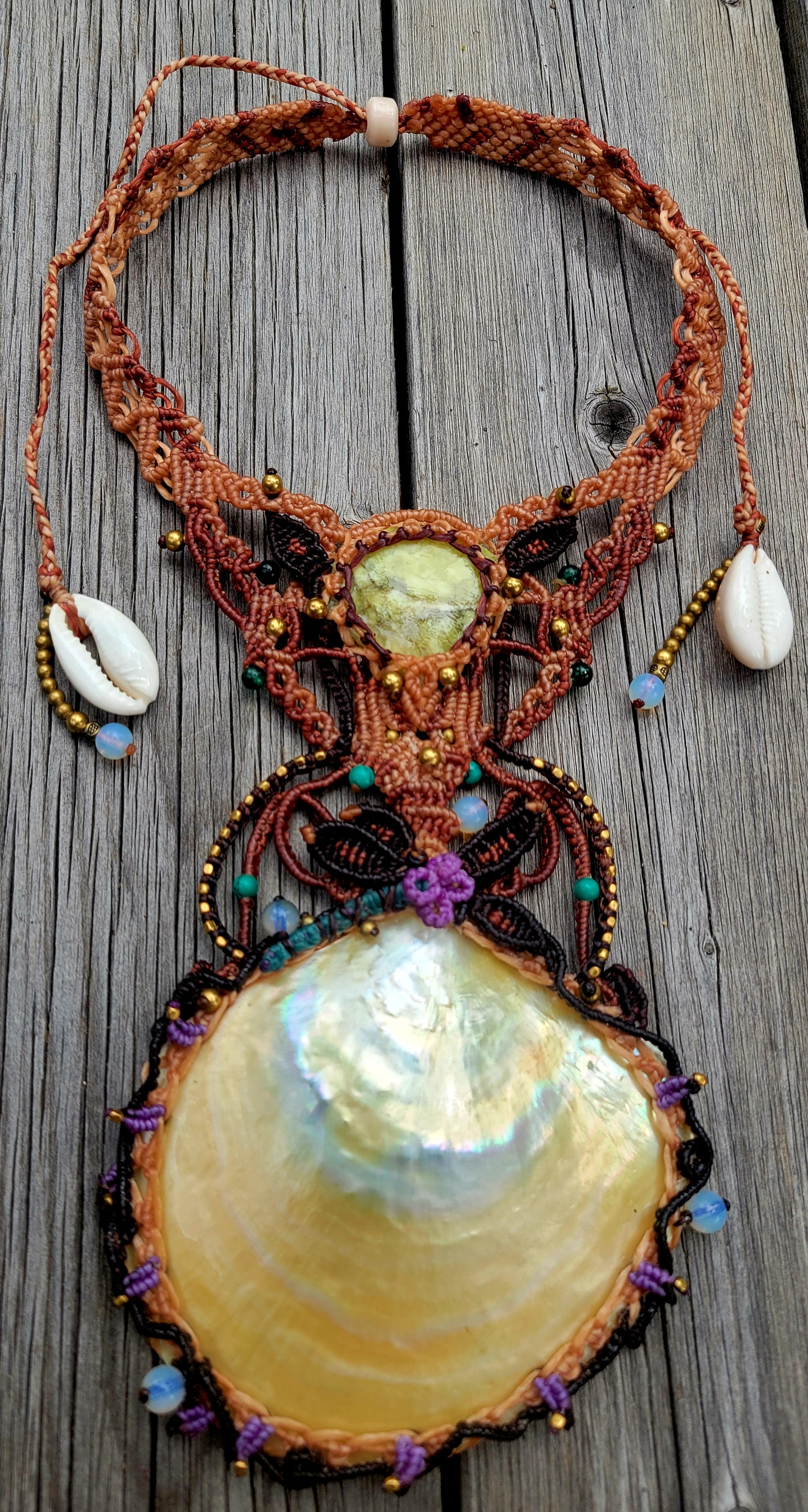 Mother of Pearl Shell Necklace featuring a large pendant and unique micromacramé design, accentuated with gemstones.