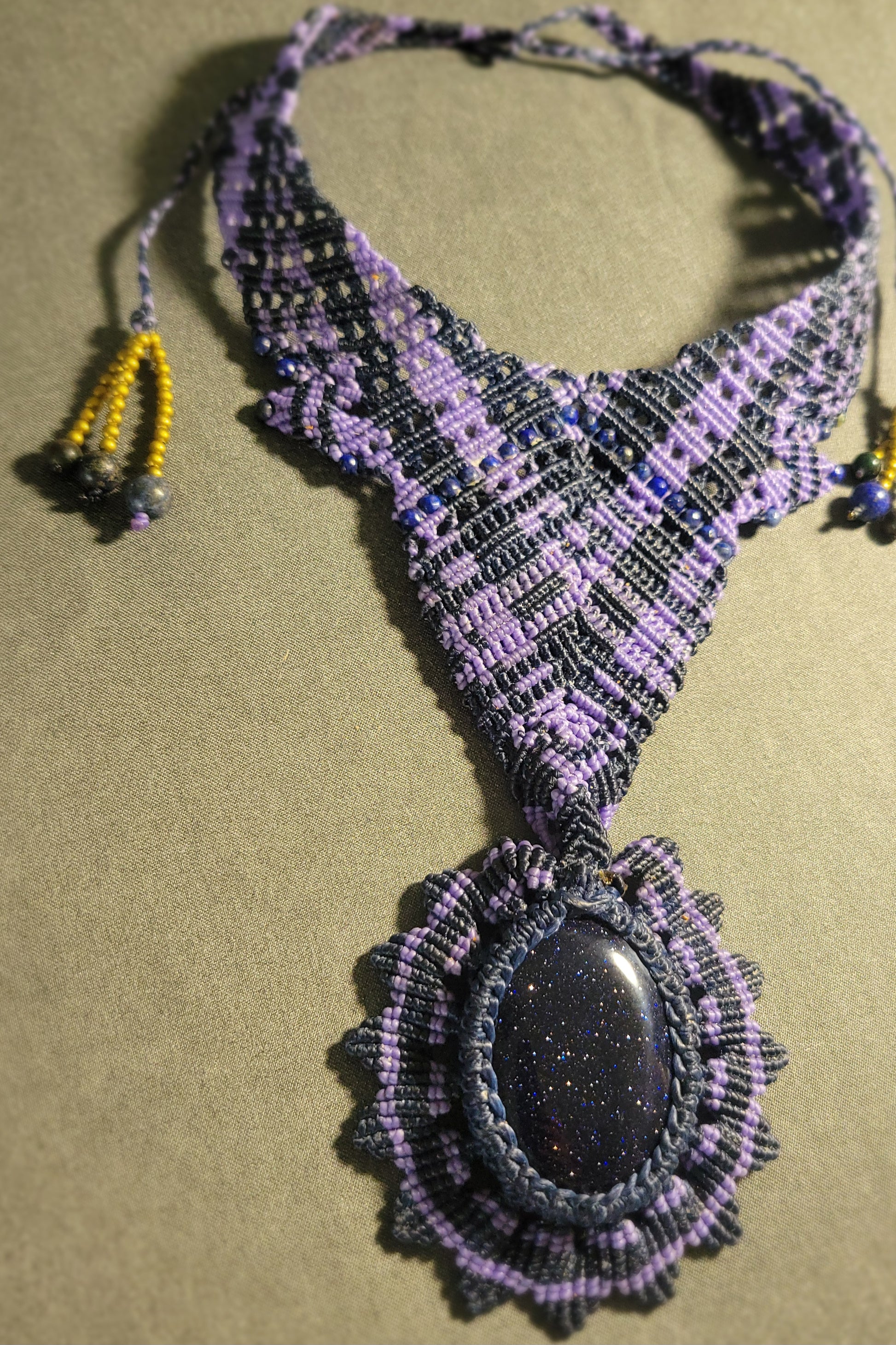 Handmade Boho Necklace featuring a blue sandstone pendant and intricate purple macramé design.