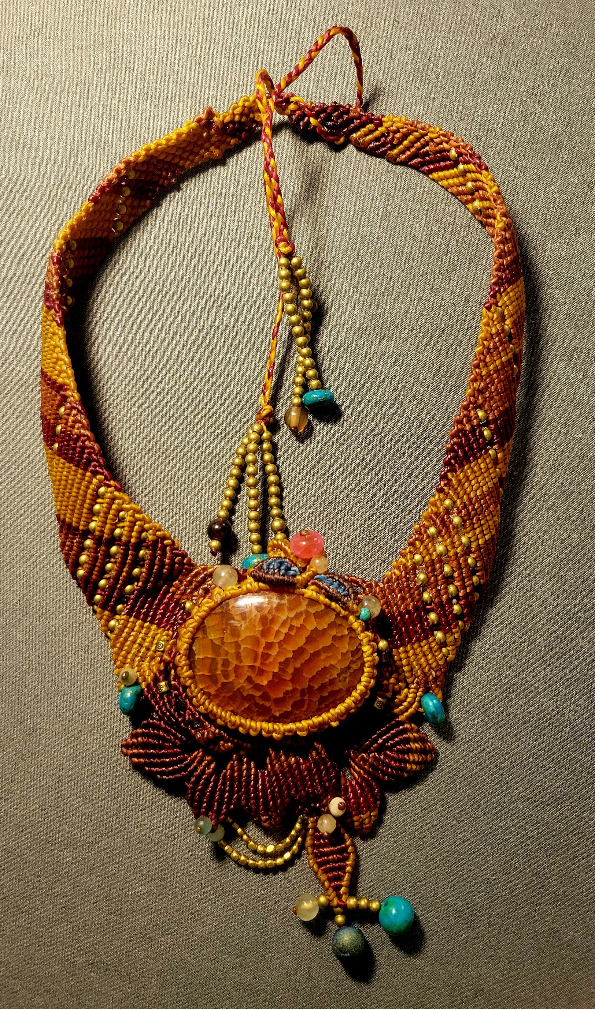 Fire Agate Earthfire Ritual Palm Stone Choker featuring ornate micromacramé and antique brass beads.