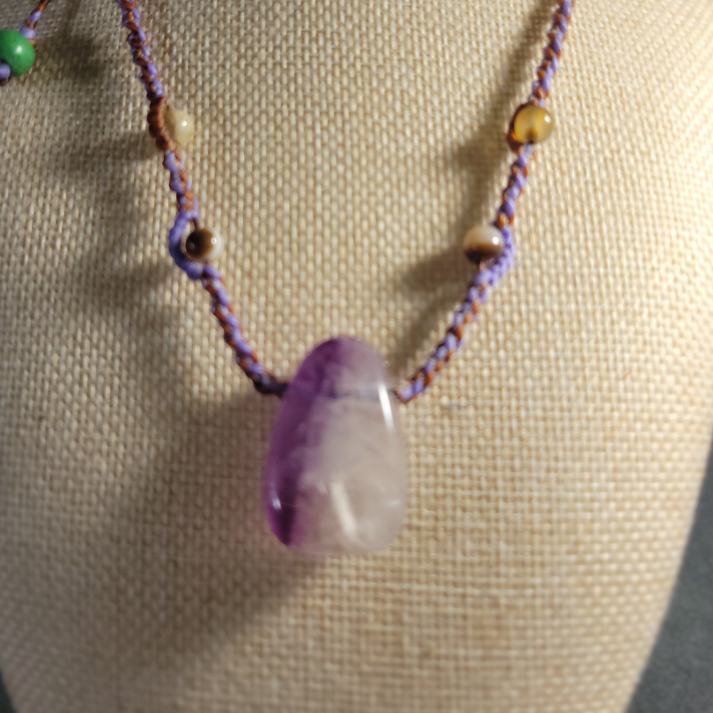 Minimalist amethyst necklace on braided brown cord
