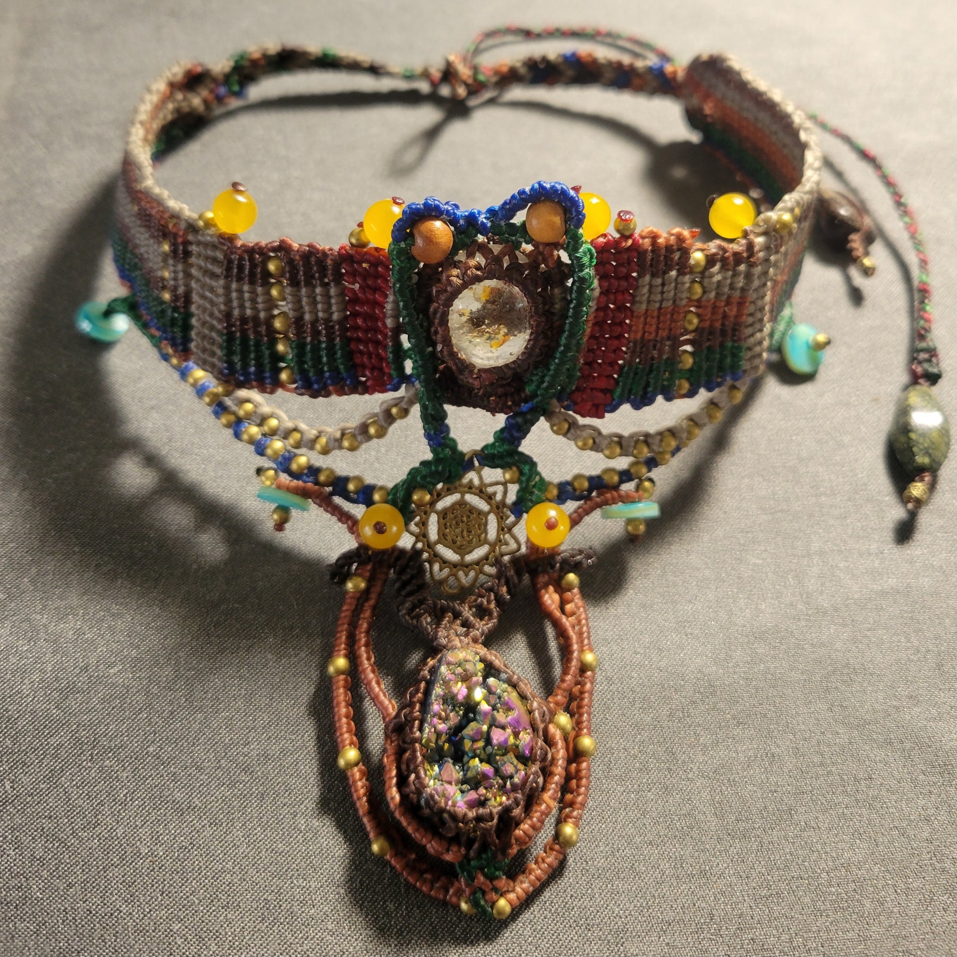 Titanium Aura Pendant – Sacred Geometry Spiritual Choker with intricate micromacramé design and colorful beads.
