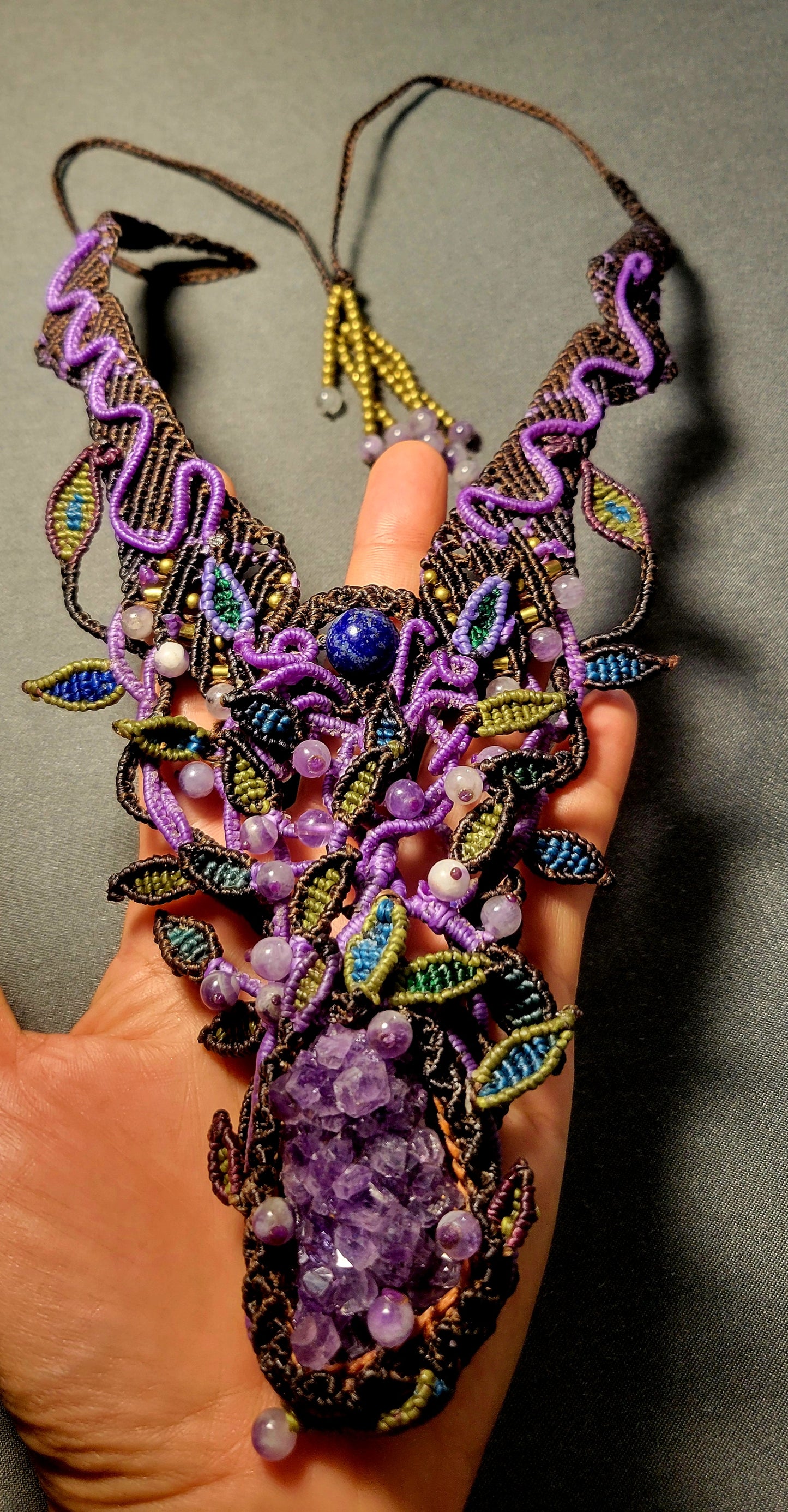 Amethyst Pendant – Large raw amethyst crystal and micromacramé choker with intricate vine patterns in purple and brown.
