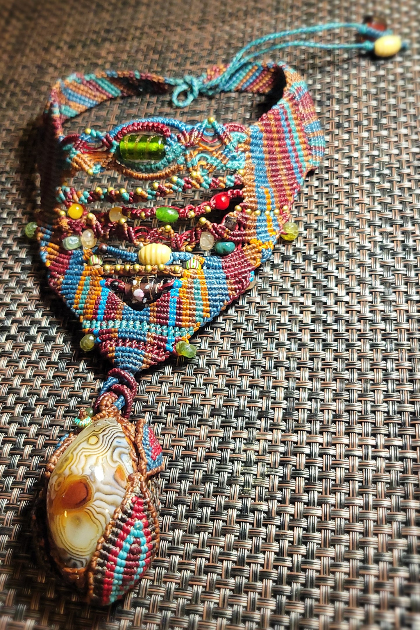 Botswana Agate Pendant showcasing intricate micromacramé and colorful beads, perfect tribal-inspired choker.