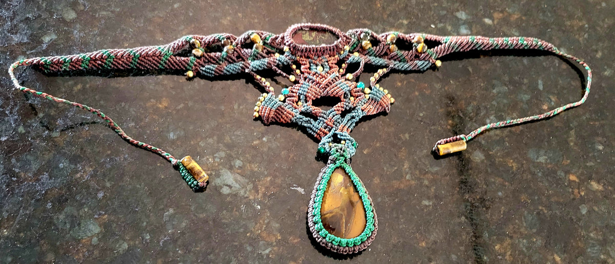 Iron Tiger's Eye Pendant showcased in a micromacramé choker with colorful cord and intricate knotwork.