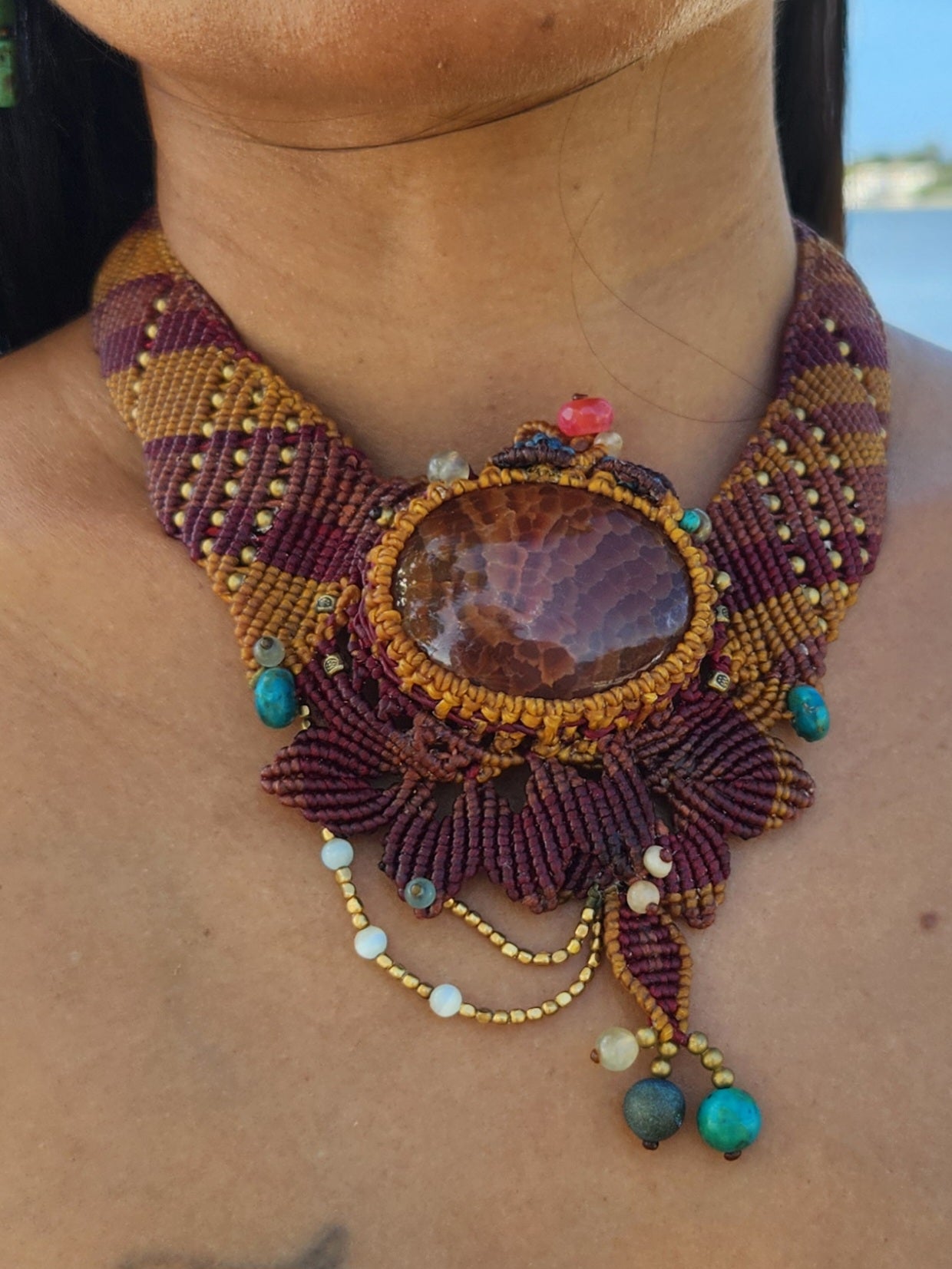 Fire Agate choker necklace featuring ornate micromacramé wrapping and antique brass bead accents.