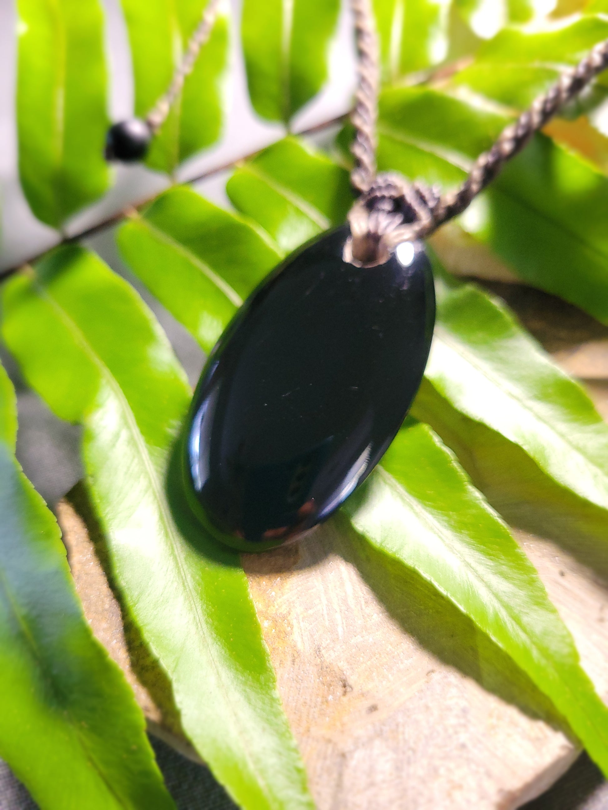 Black Onyx Necklace – Midnight Wanderer Talisman featuring natural oval black onyx pendant on macramé cord.