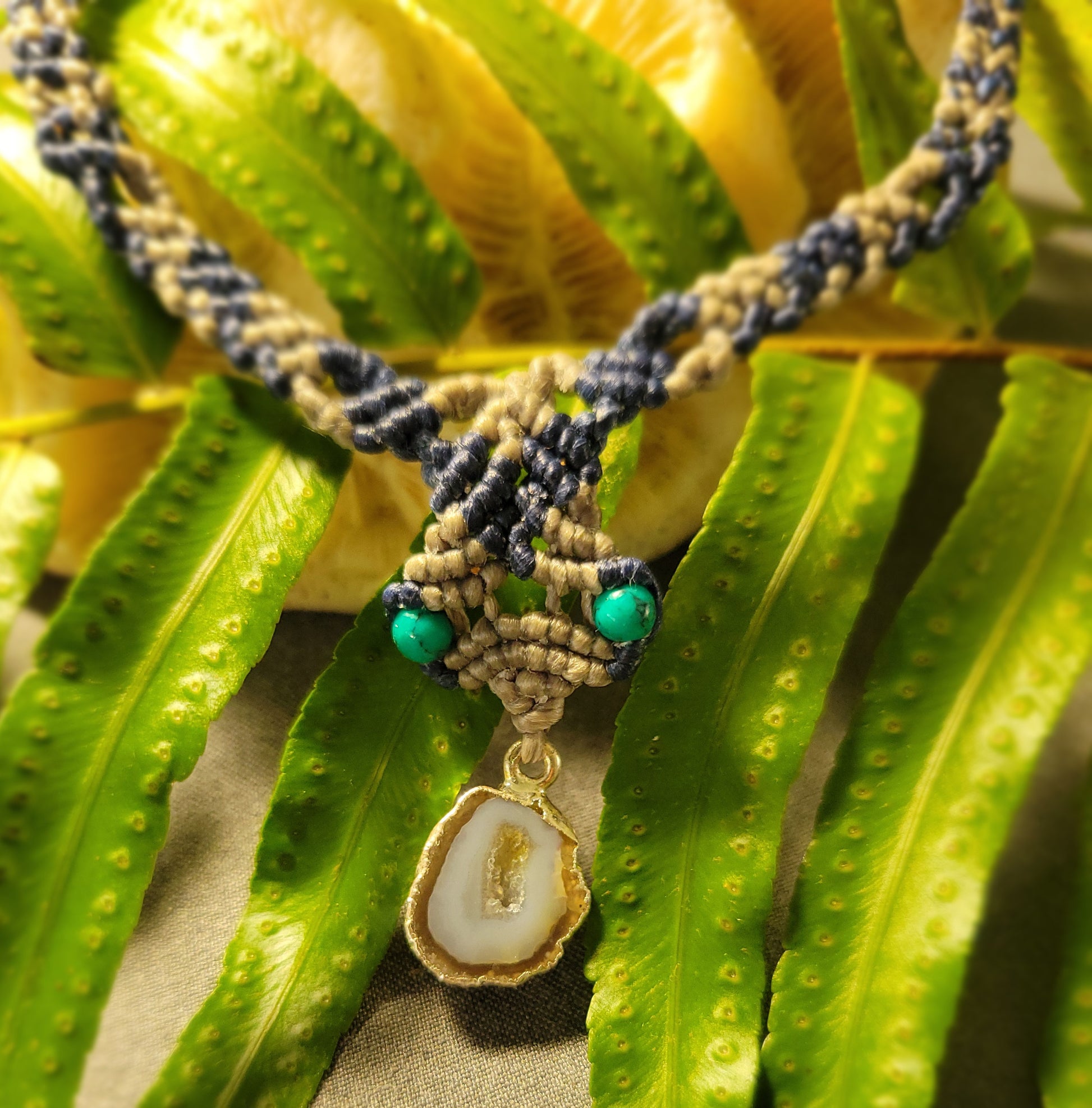 Agate Geode Necklace – Natural Slice with Malachite Accents featuring a unique pendant and braided cord.