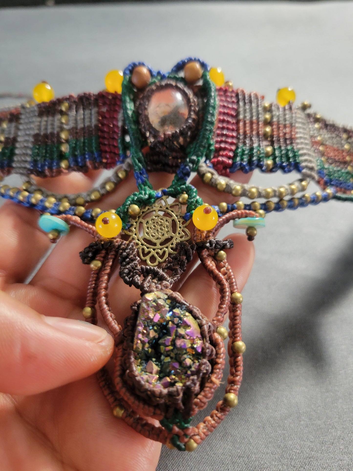 Titanium Aura Pendant – Sacred Geometry Spiritual Choker featuring intricate micromacramé and colorful embellishments.