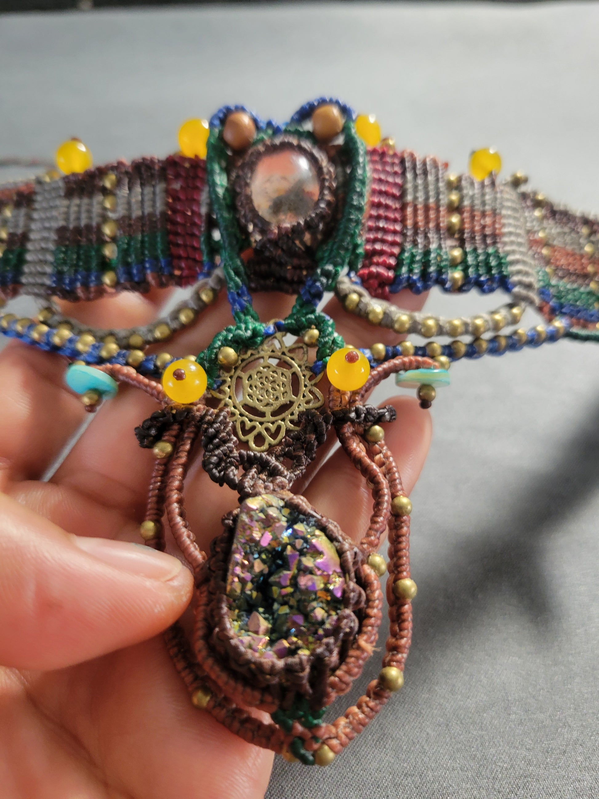 Titanium Aura Pendant – Sacred Geometry Spiritual Choker featuring intricate micromacramé and colorful embellishments.