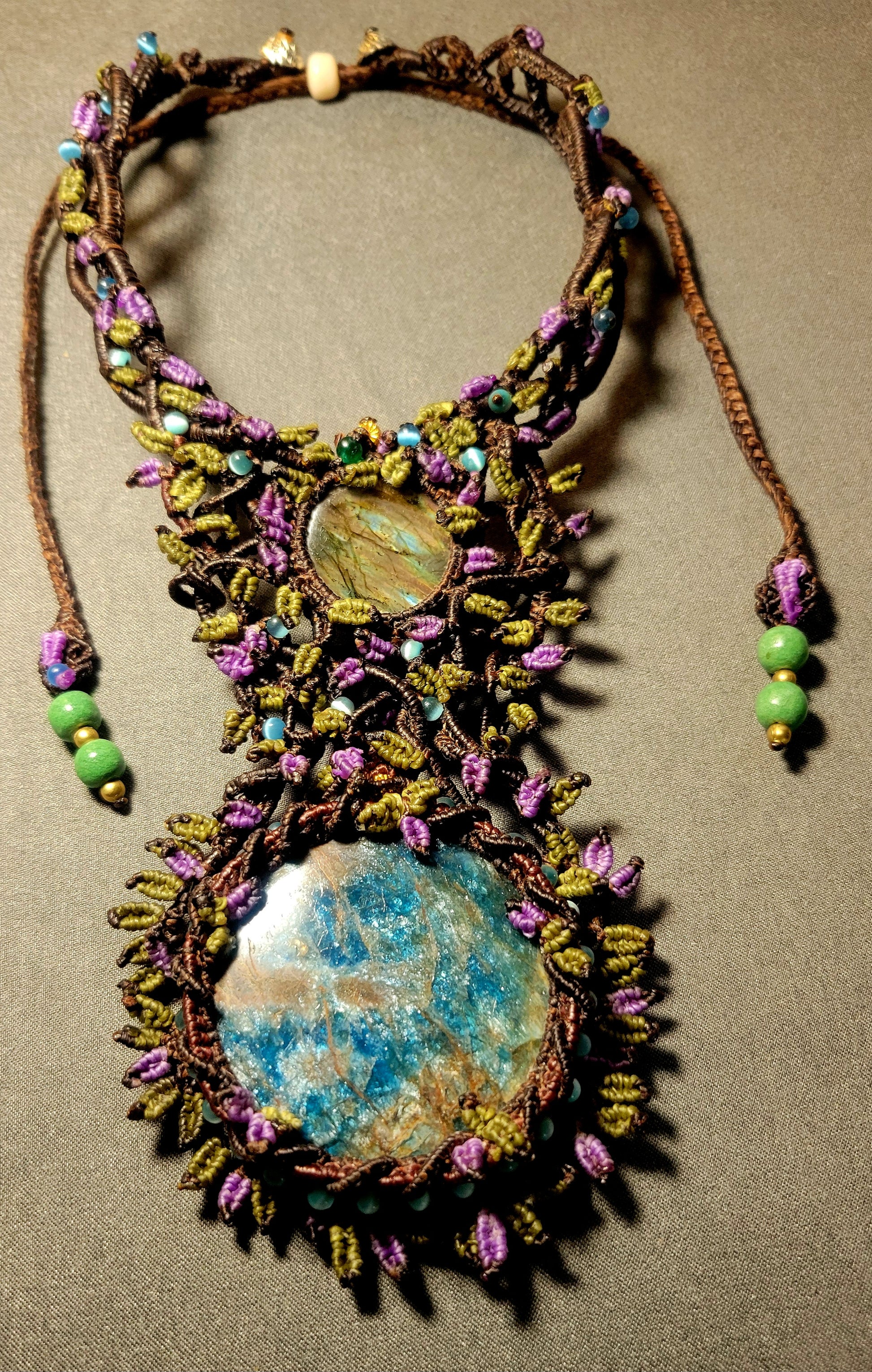 Apatite Pendant showcasing large blue apatite stone with intricate micromacramé design and gemstone beads.