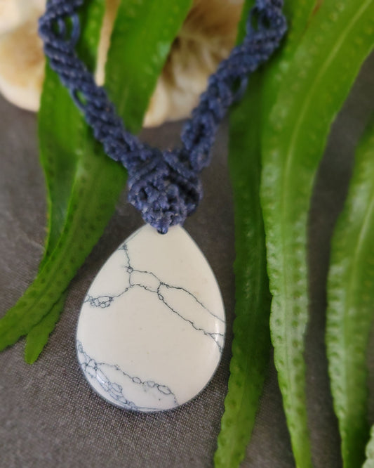 Howlite Pendant featuring a natural howlite stone on a dark blue woven macramé necklace with zig zag design.