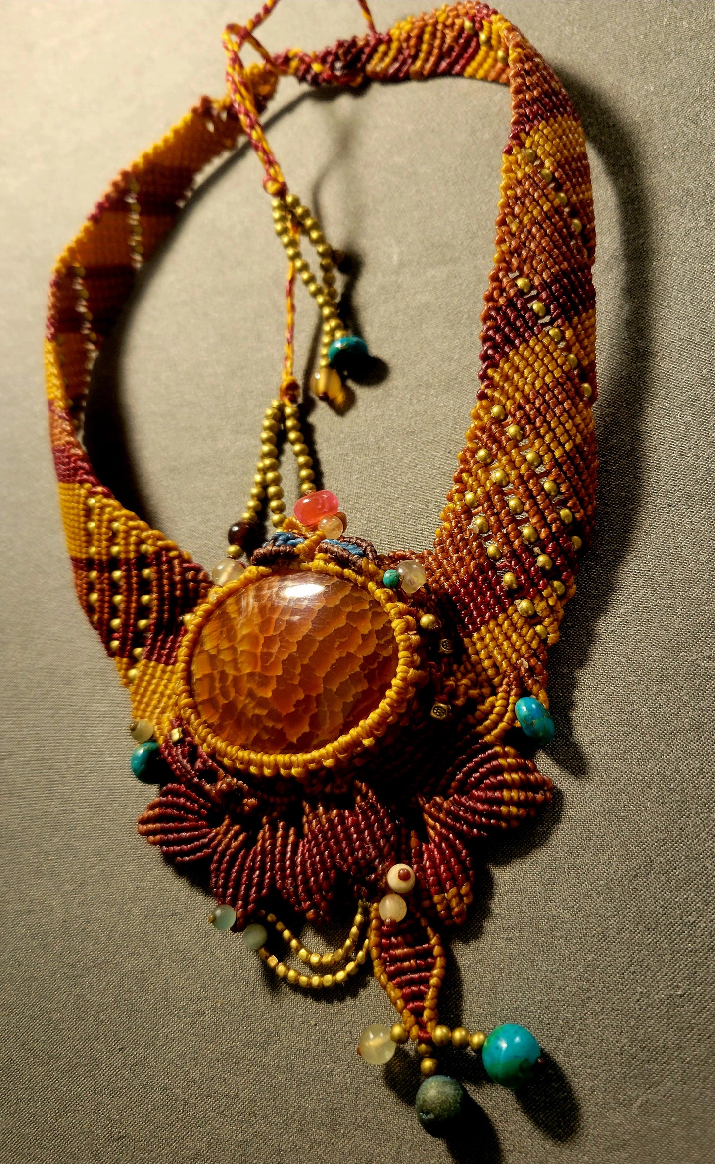Fire Agate – Earthfire Ritual Palm Stone Choker with ornate micromacramé and antique brass bead accents.