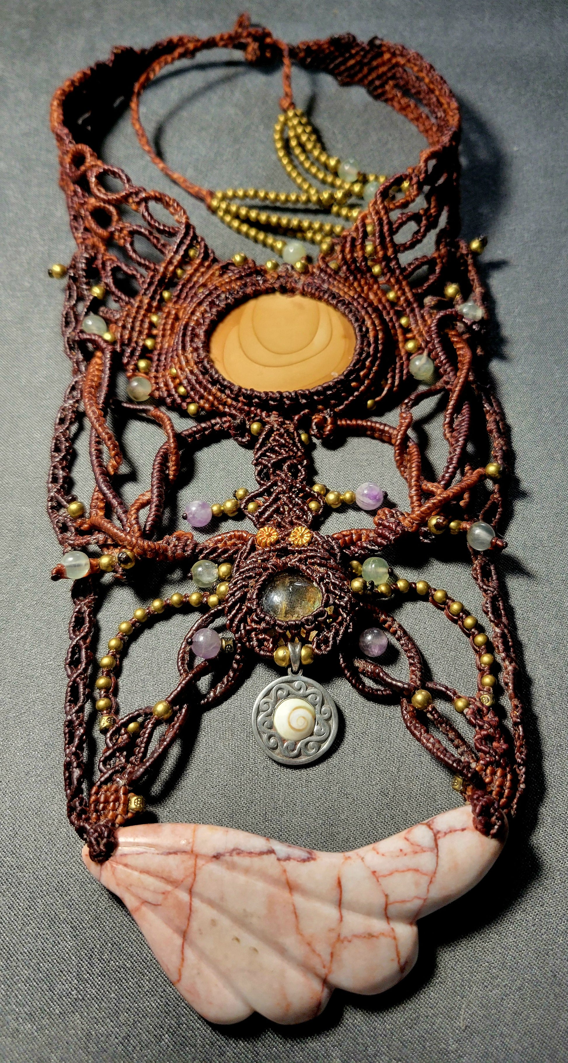 Jasper Necklace featuring a hand-carved red vein jasper angel wing and ornate micromacramé design. Unique talisman piece.