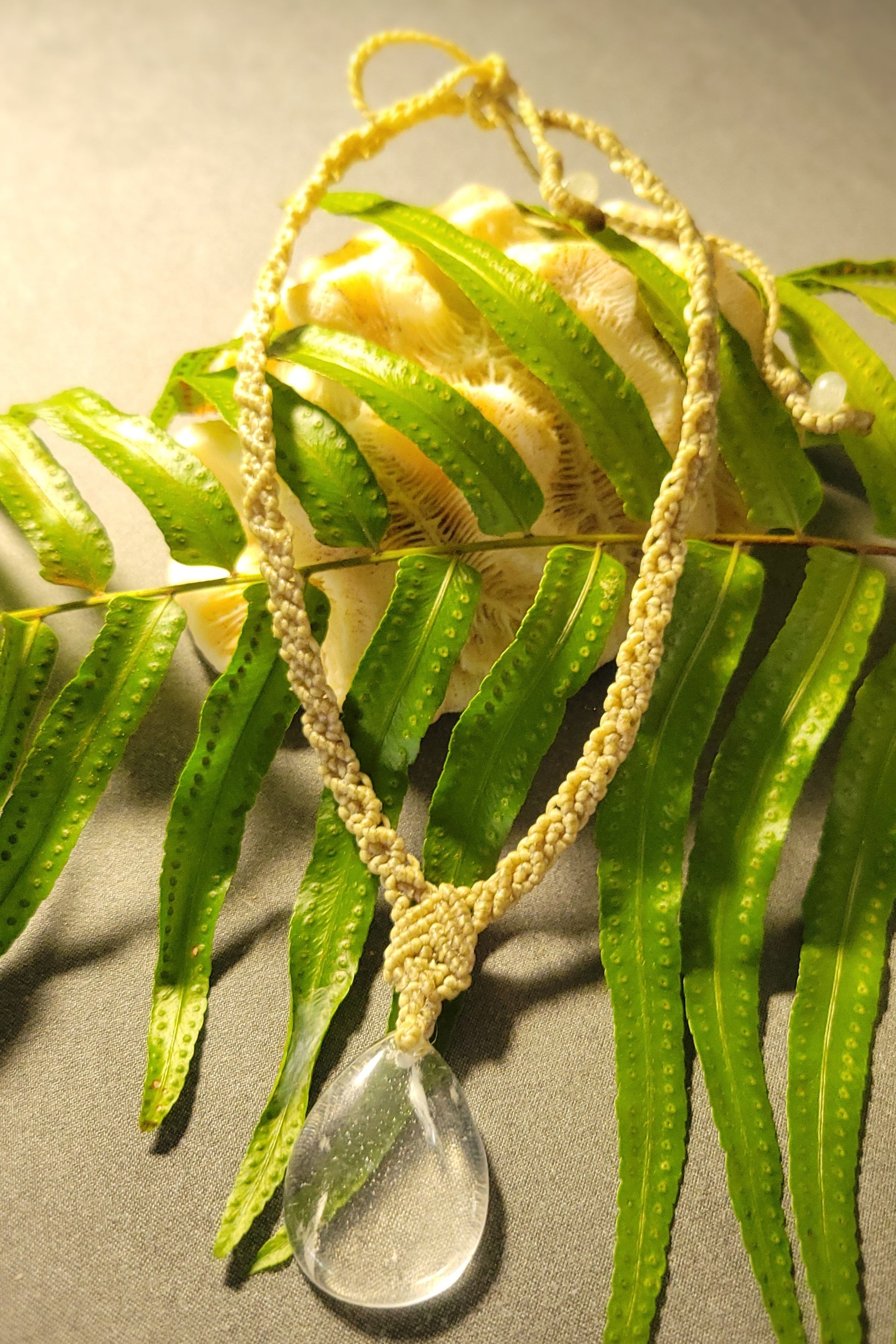 Quartz Necklace – Drop Crystal Boho Chic Macramé Design featuring a clear quartz pendant on a handwoven cord.