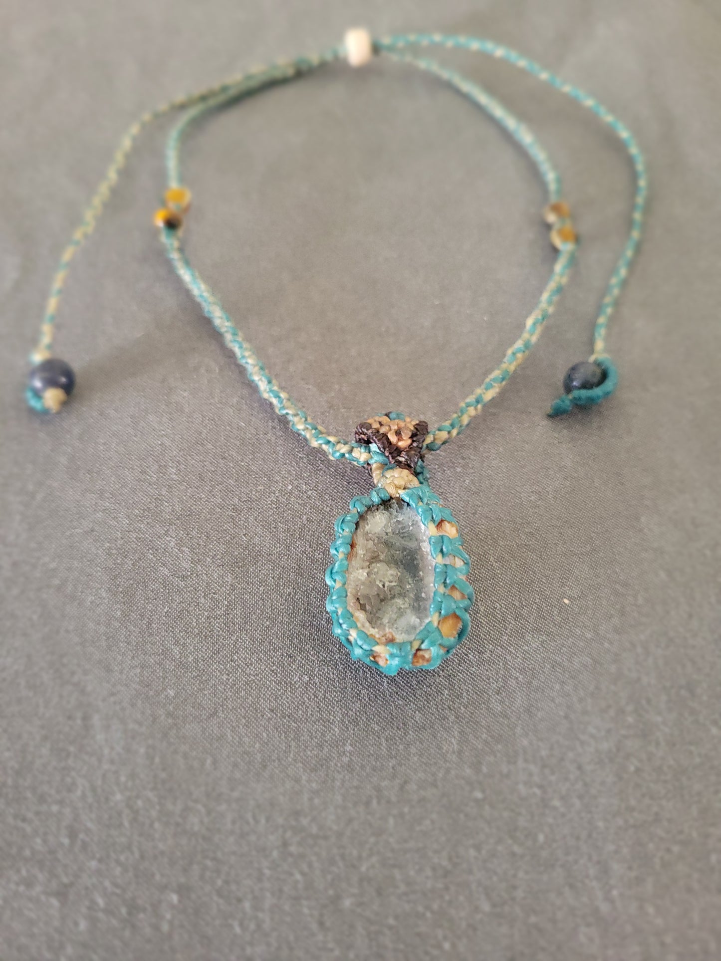 Agate Necklace – 'Shining with Grace' Natural Geode Pendant on a grey backdrop with aquamarine accents.