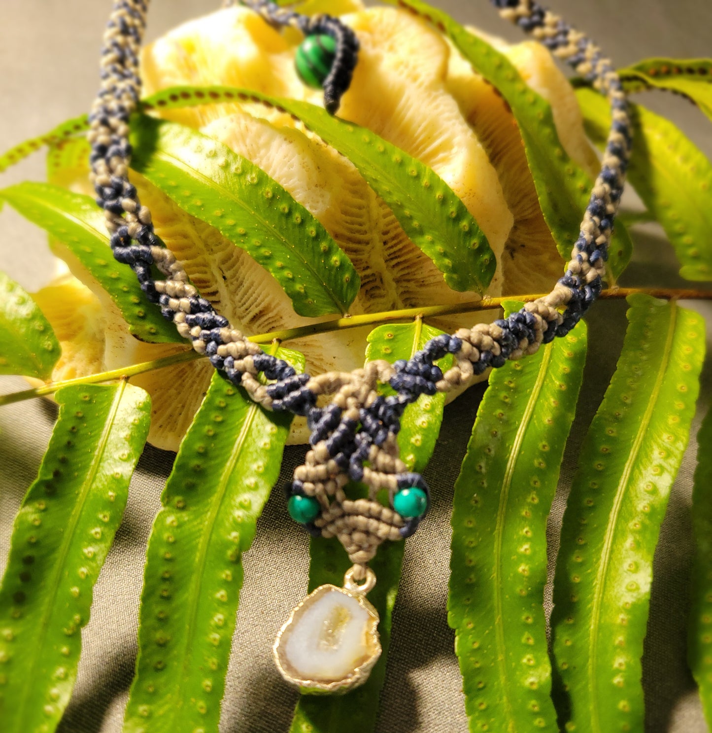 Agate Geode Necklace – Natural slice with malachite accents on a green and black cord.