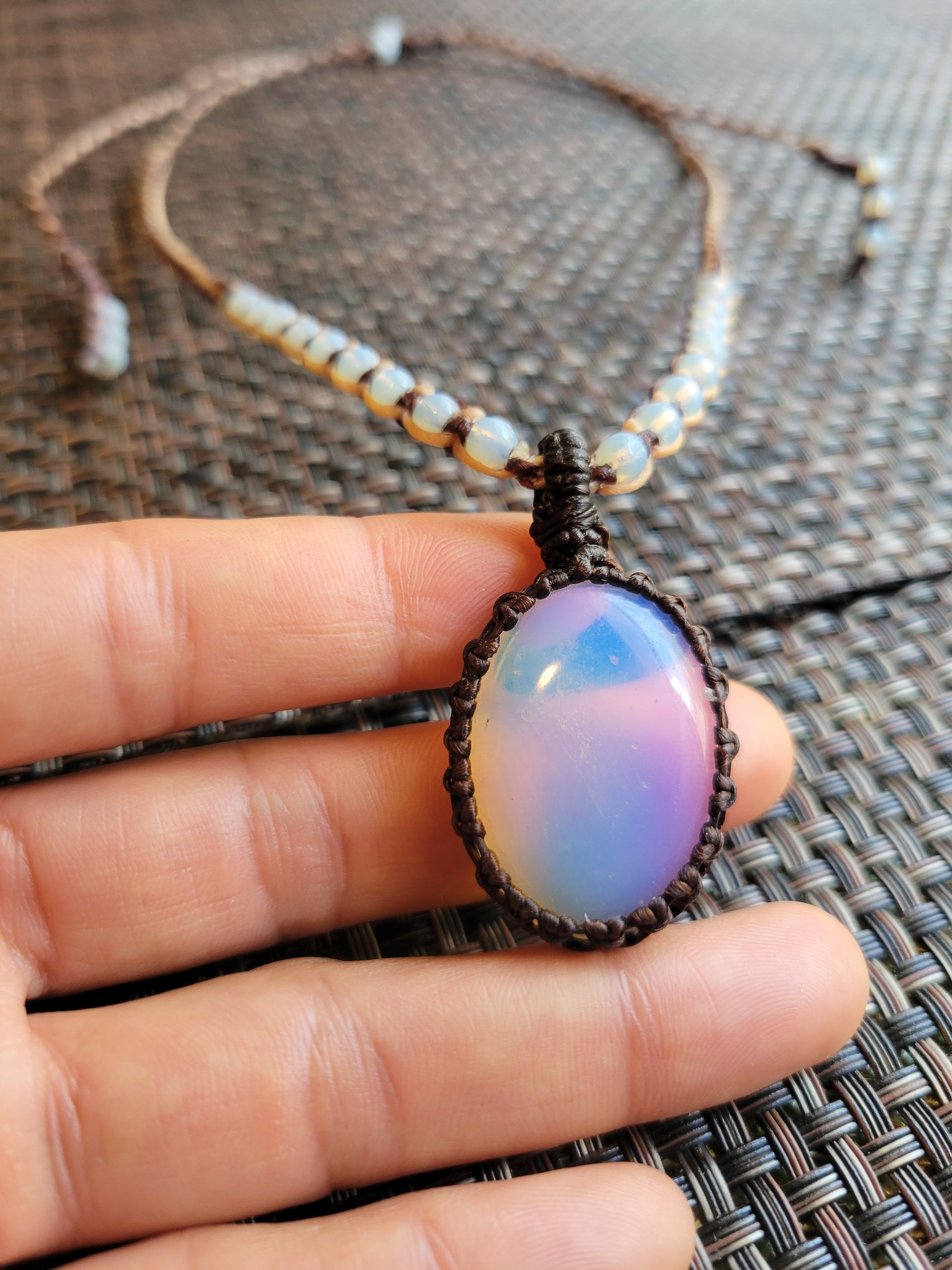 Opalite Pendant Necklace showcasing a smooth opalite stone in a handmade macramé design with matching bead details.
