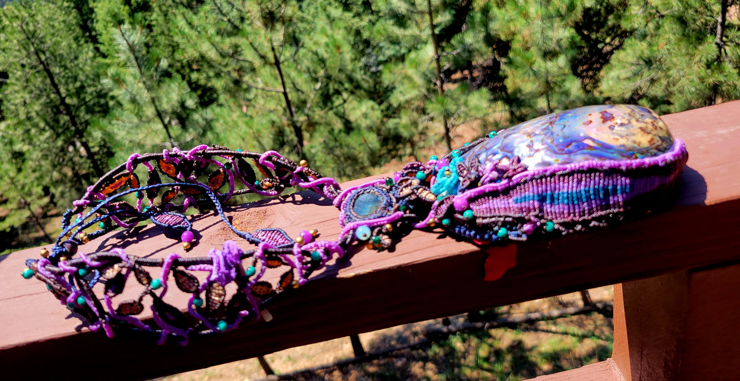 Ocean Necklace featuring a large Australian abalone shell and intricate micromacramé design with colorful stones.