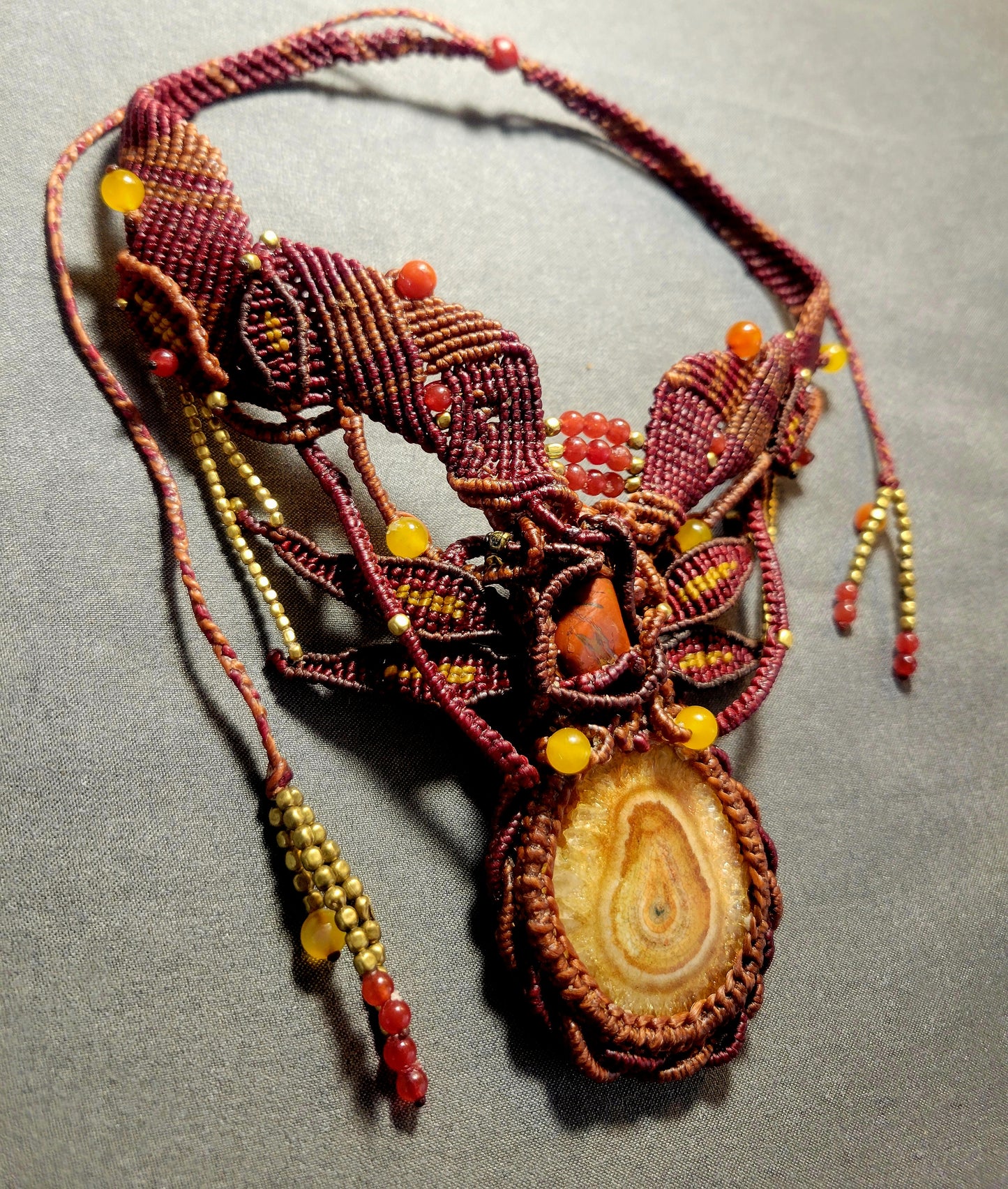 Agate Boho Necklace featuring a honey yellow agate stalactite slice and red carnelian beads on a macramé choker.