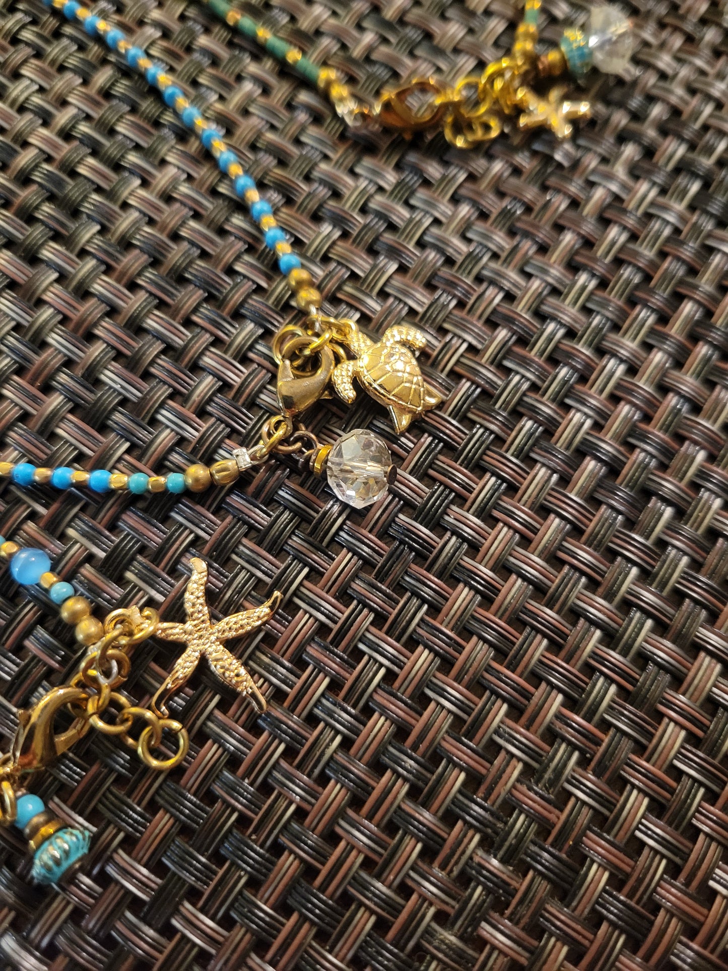 Boho Anklets featuring beaded design with ocean charms including sea star and turtle on a woven background.