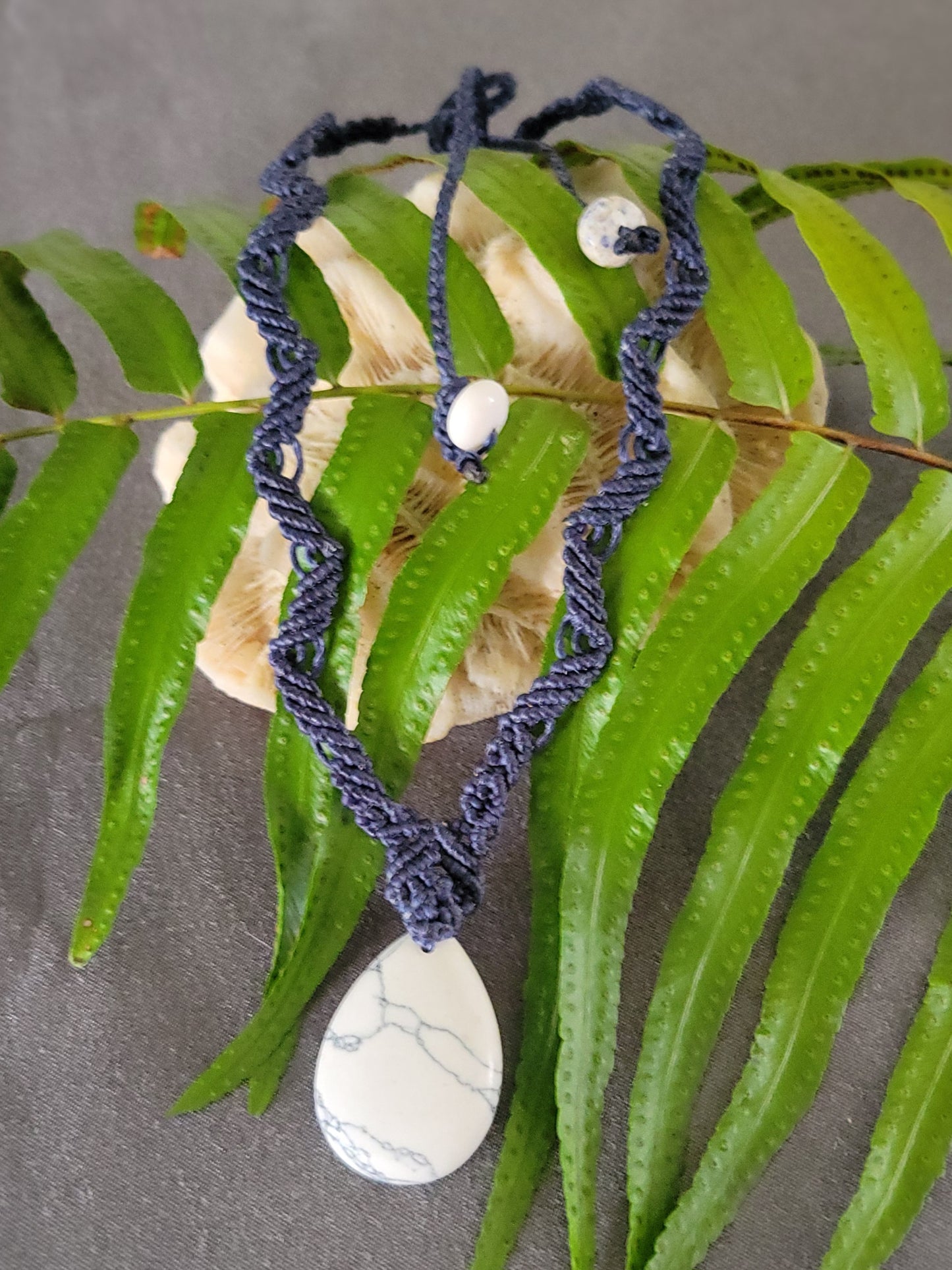 Howlite Pendant – Blue Woven Boho Zig Zag Macramé Necklace featuring a natural howlite stone and dark blue woven design.