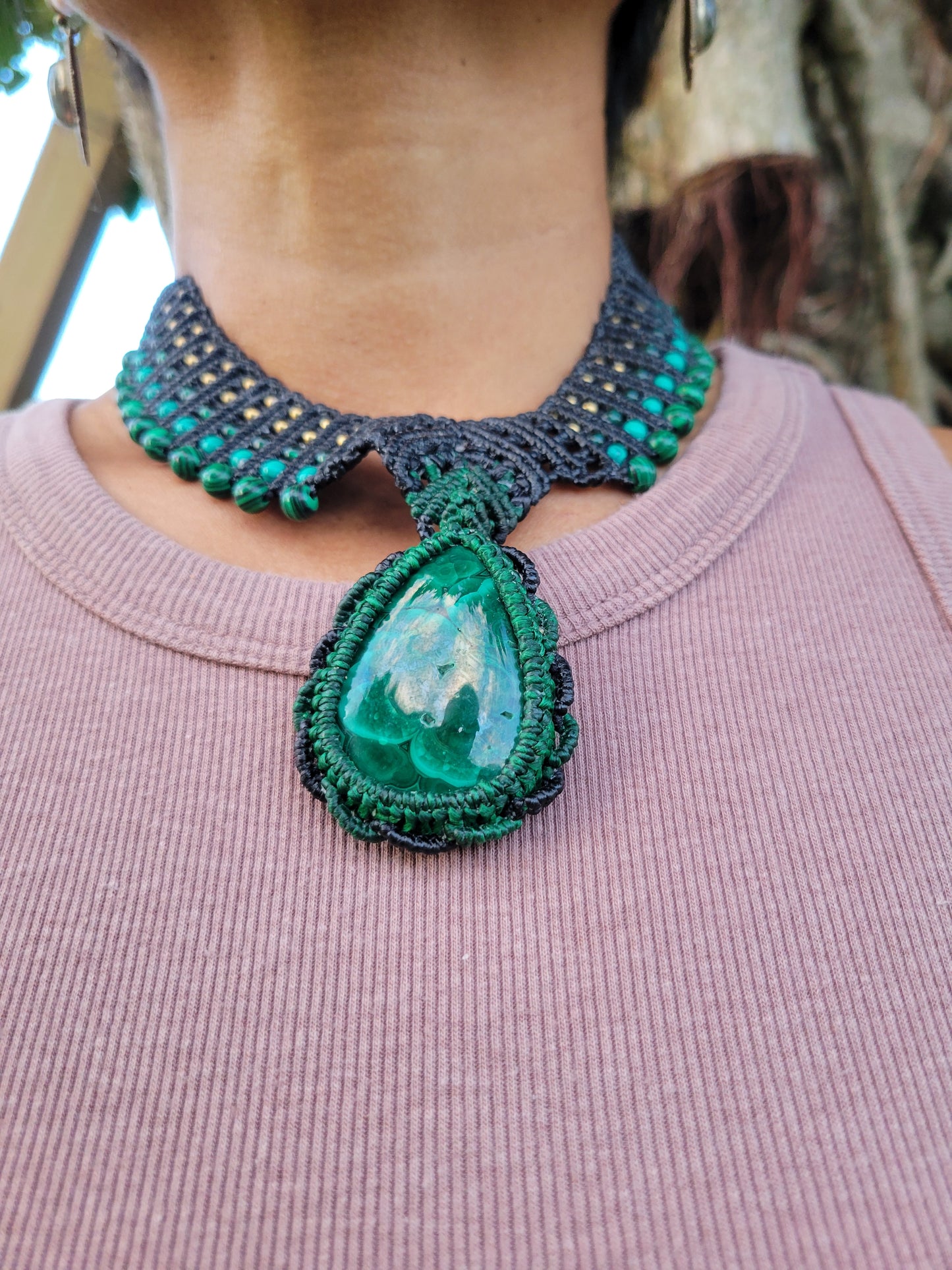 Malachite Pendant Necklace featuring a large natural stone on a macramé choker with green beads and adjustable tie closure.