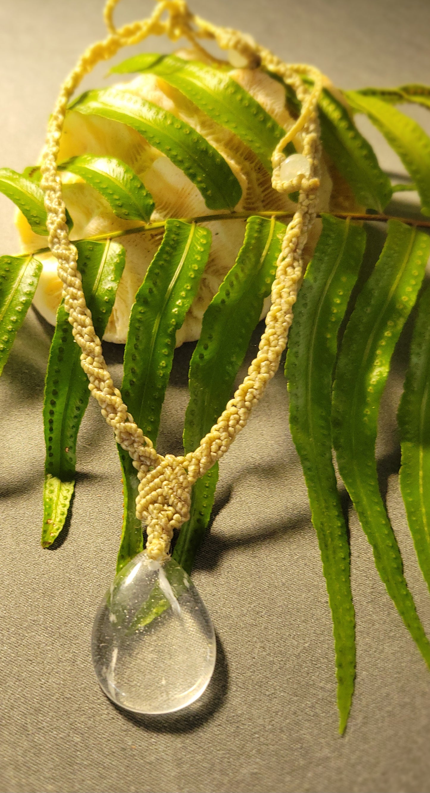 Quartz Necklace – Drop Crystal Boho Chic Macramé Design with natural clear quartz pendant on a leaf.