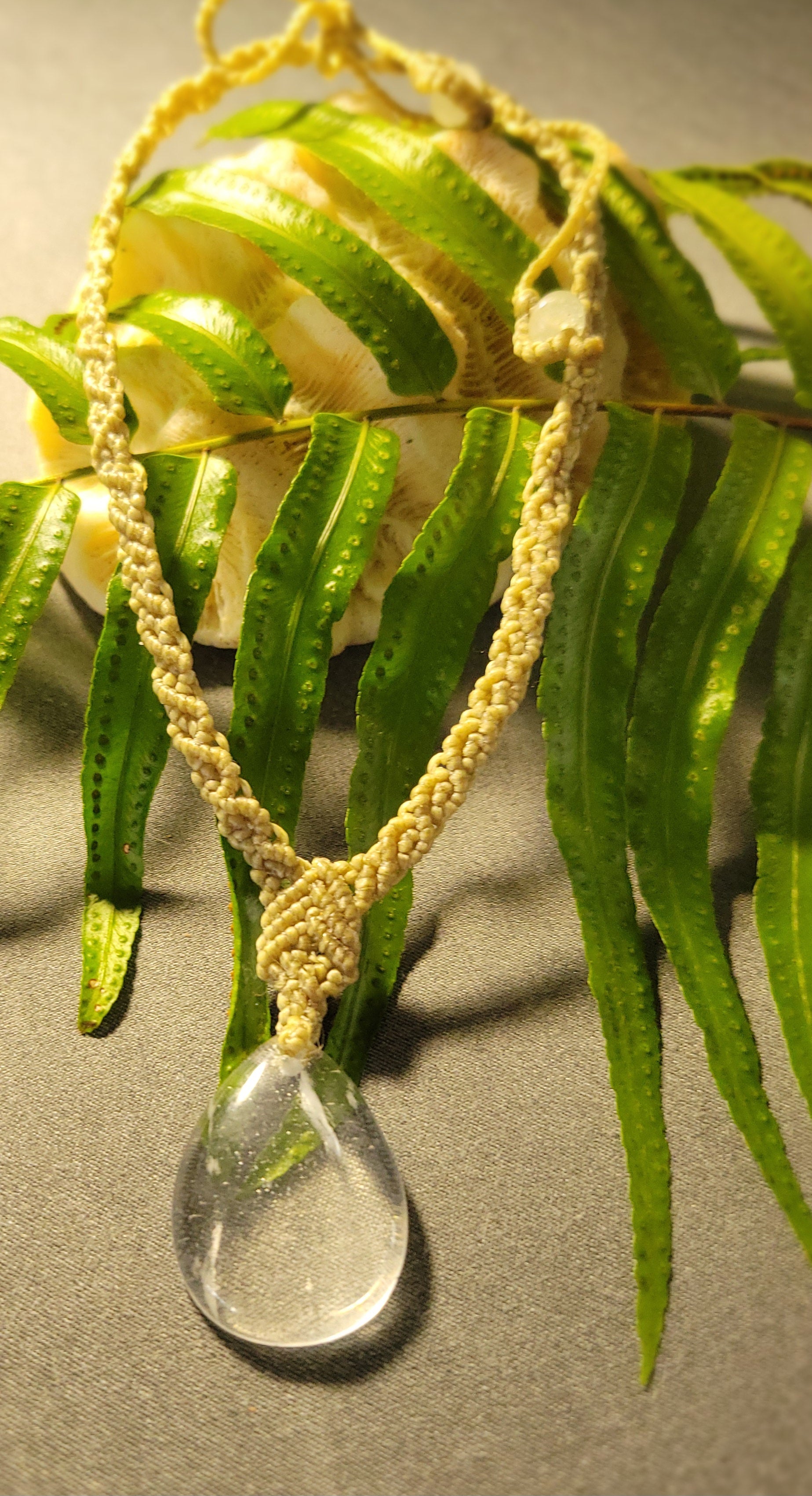 Quartz Necklace – Drop Crystal Boho Chic Macramé Design with natural clear quartz pendant on a leaf.