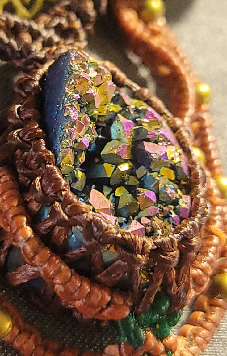 Close-up of a Titanium Aura Pendant featuring a sparkling crystal in intricate micromacramé design.