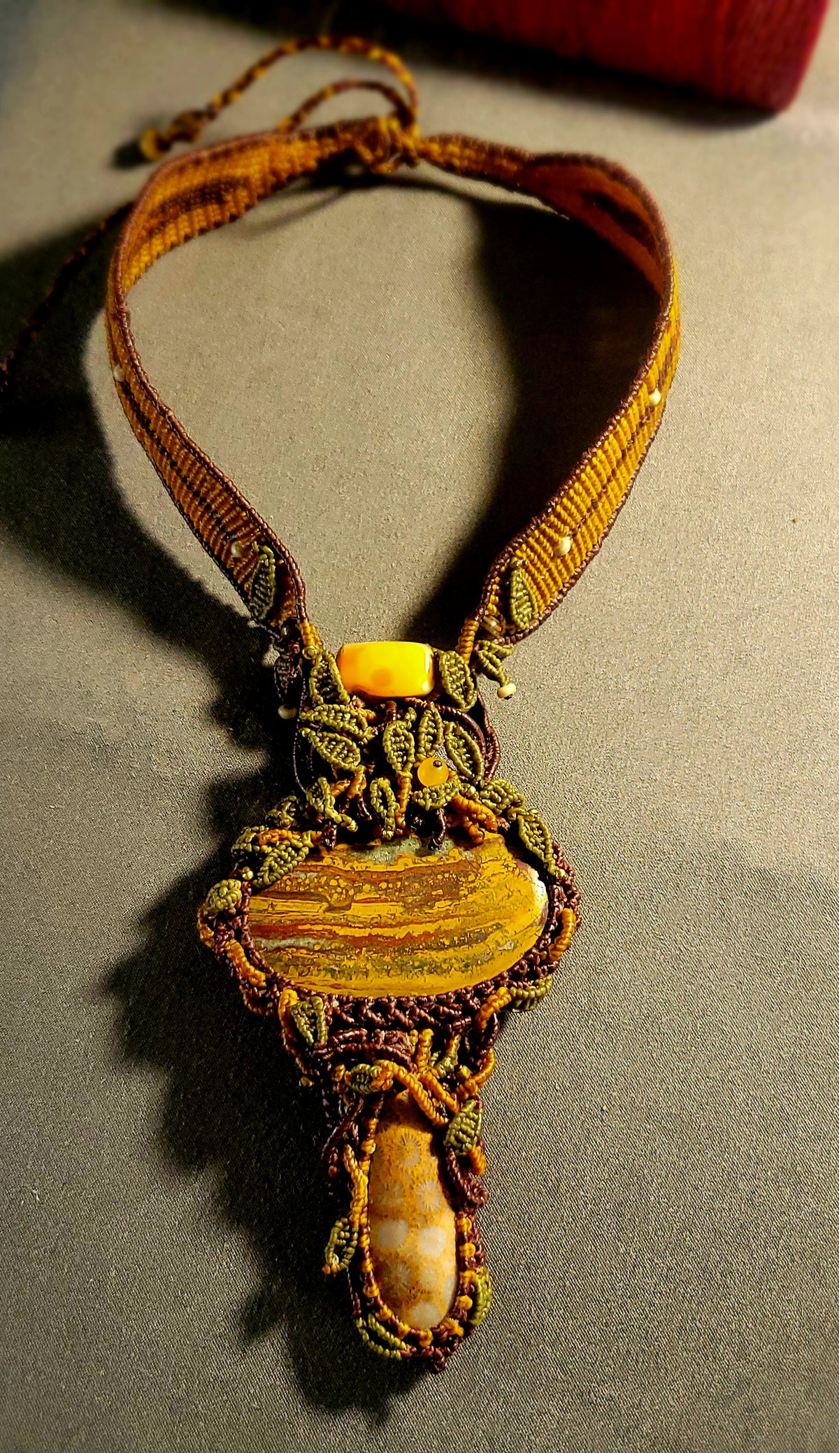 Tiger’s Eye Pendant featuring natural iron tiger’s eye stone and ornate micromacramé choker design.