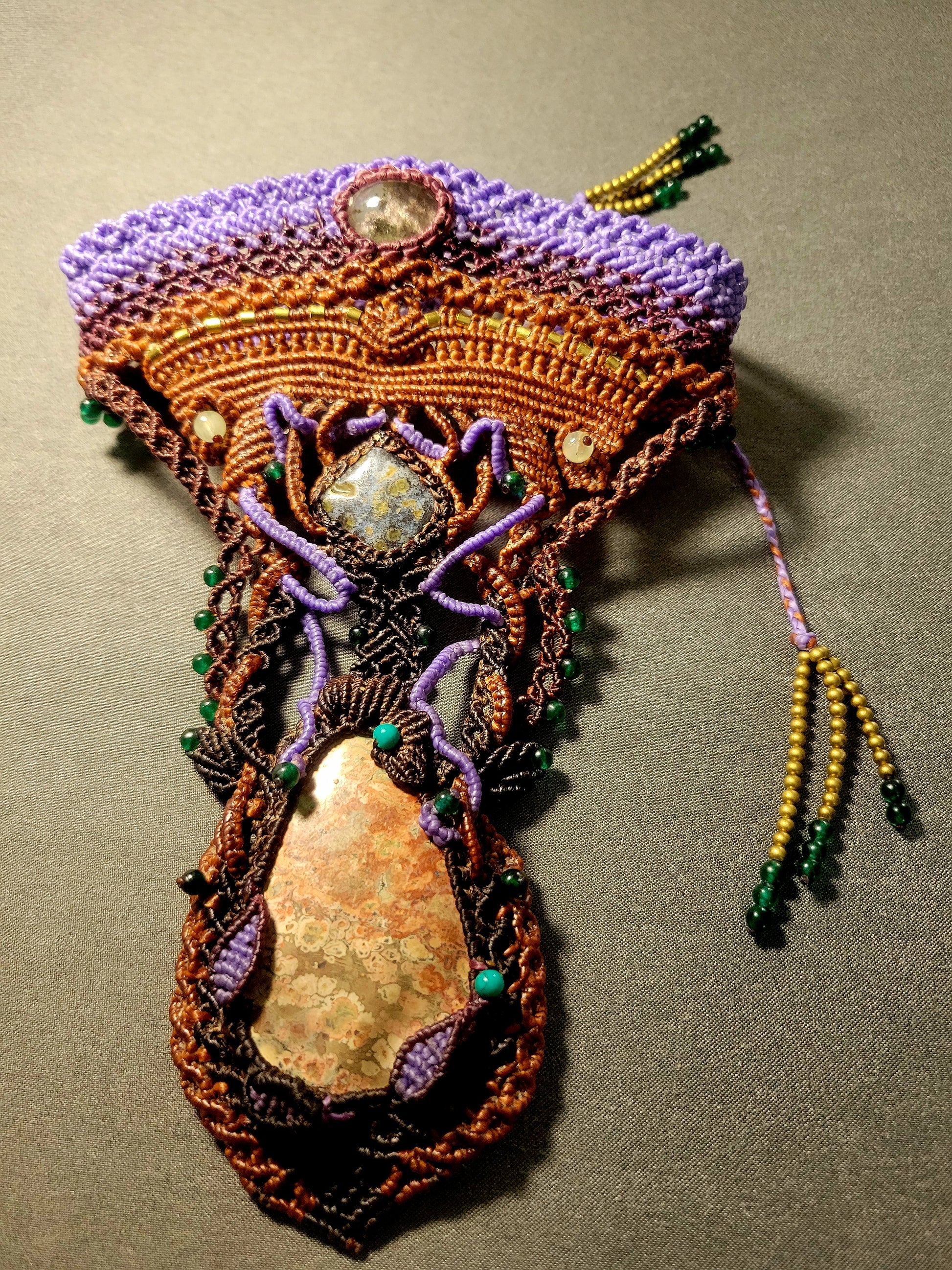 Poppy Jasper Pendant featuring large natural stone, ornate micromacramé design and tribal influences.