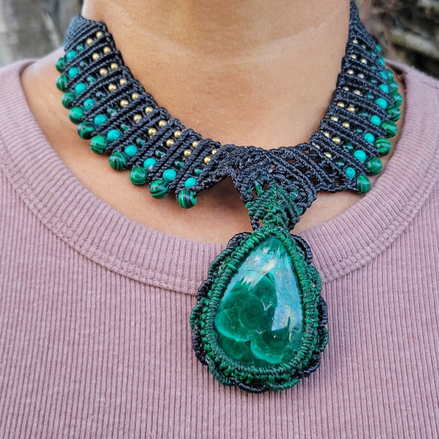 Malachite Pendant Necklace featuring a large natural malachite stone with concentric green rings and macramé design.